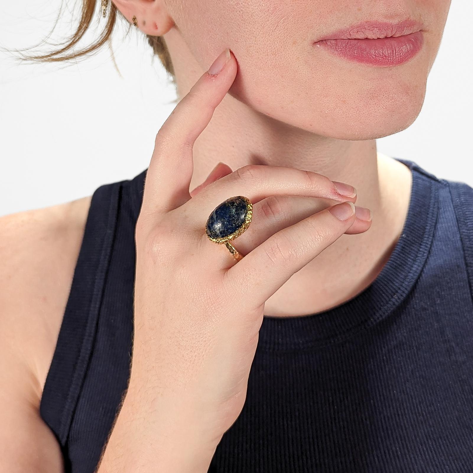 A very fine 18k gold and lapis cocktail ring by designer Erwin Pearl.

The asymmetrical ring features an oval lapis lazuli cabochon in an organic bezel setting. 

Terrific modernist design!

Date:
20th Century

Overall Condition:
It is in overall