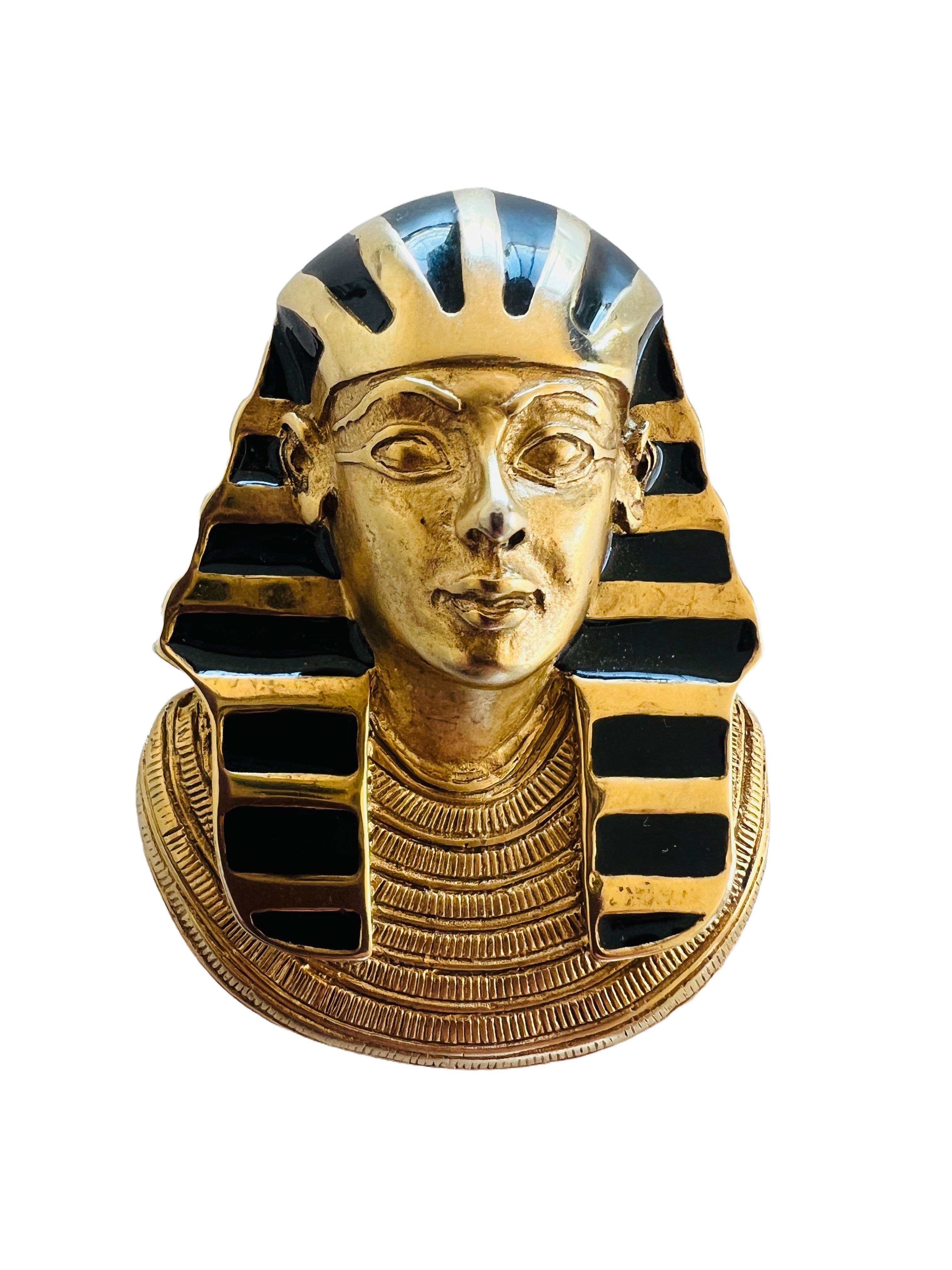 This striking Erwin Pearl piece captures the iconic King Tut in a bold Egyptian Revival style. Crafted with attention to detail, it features a black enamel headdress set against rich, gold-tone metal, giving it a regal and timeless look. This