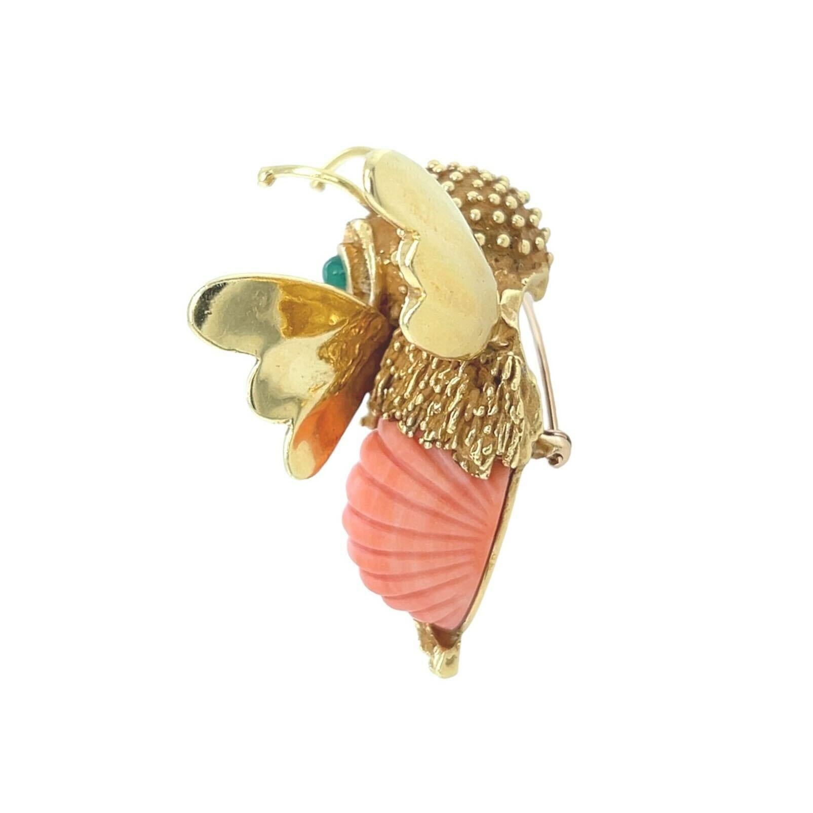 An 18 karat yellow gold, coral and chrysoprase bee brooch, Erwin Pearl.  Designed as a bee, its abdomen formed by a fluted oval light orange coral, its eyes of two round cabochon chrysoprases, its head of beadwork texture and thorax of shaggy