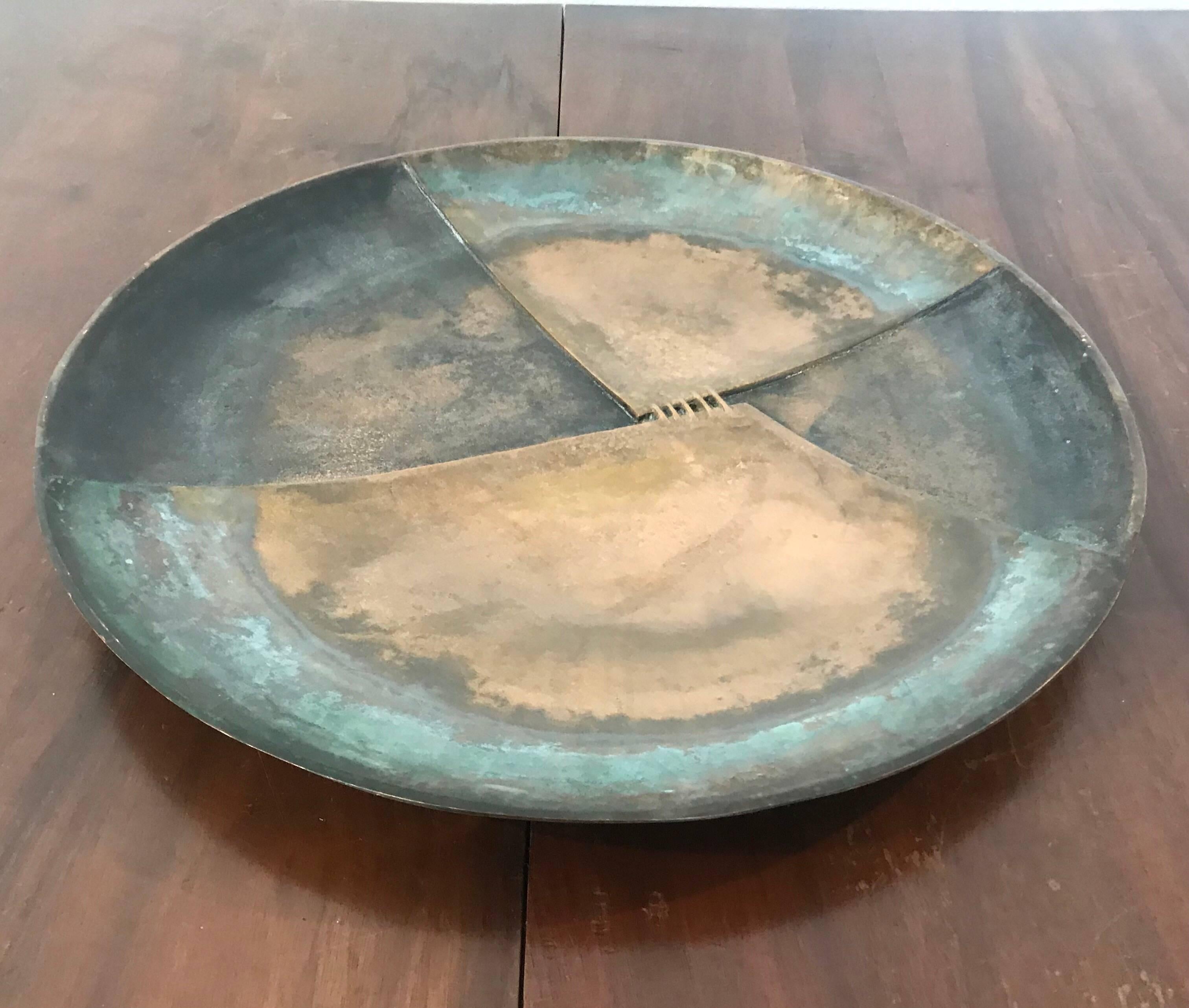A large sculptural centrepiece by the Italian designer, Esa. The aged bronze has aged with colors of brown and blue/ green. The centre has a cross stitch decoration with the look of between two pieces of leather.