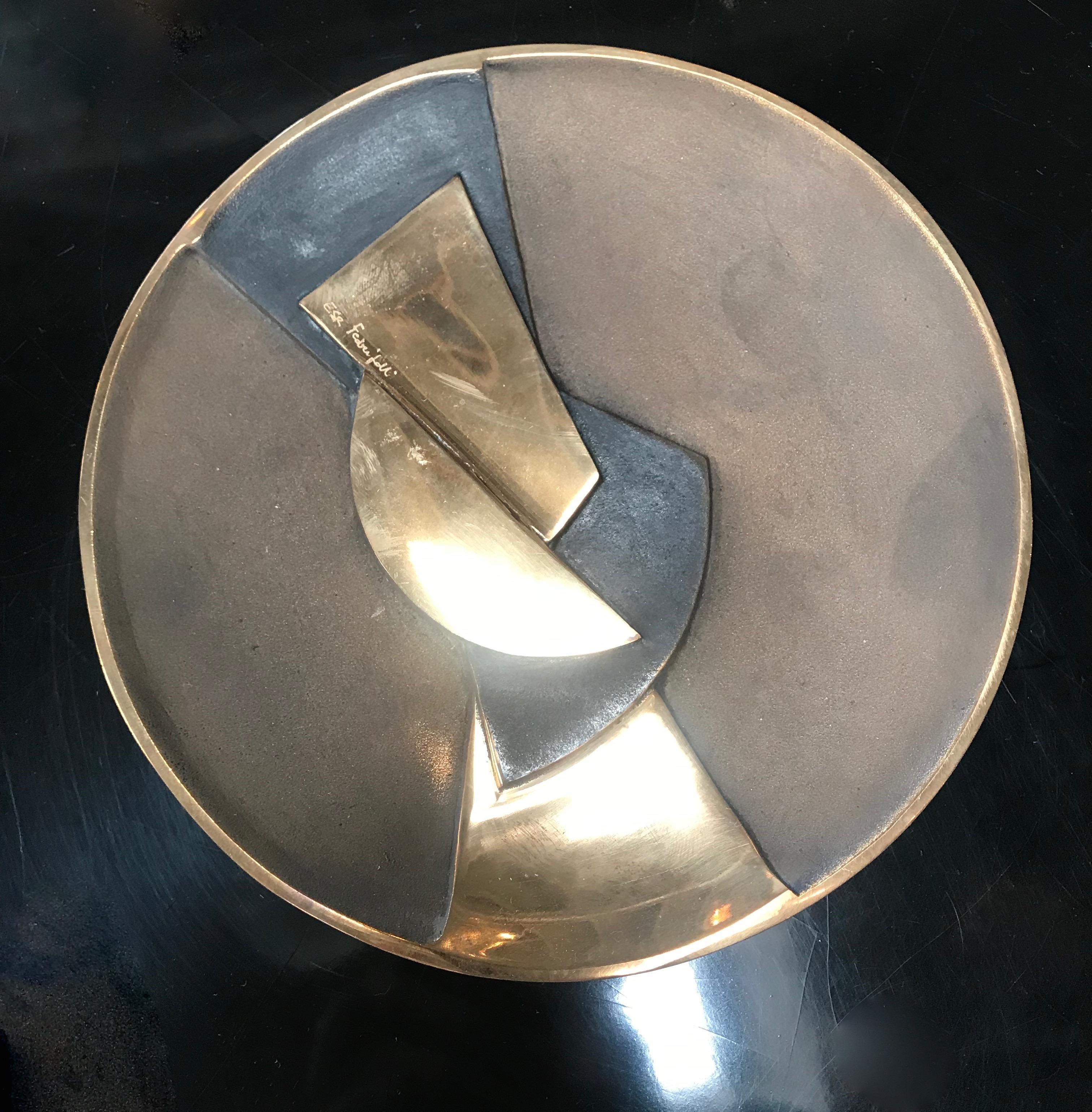 Plate/Ashtray hand-finished in three color bronze signed by E. Fedrigolli. Italy 1980.
A large sculptural centrepiece by the Italian designer, Esa. Signed by the artist and “Certificate of Authenticity”.
Esa Fedrigolli is an Italian visual artist