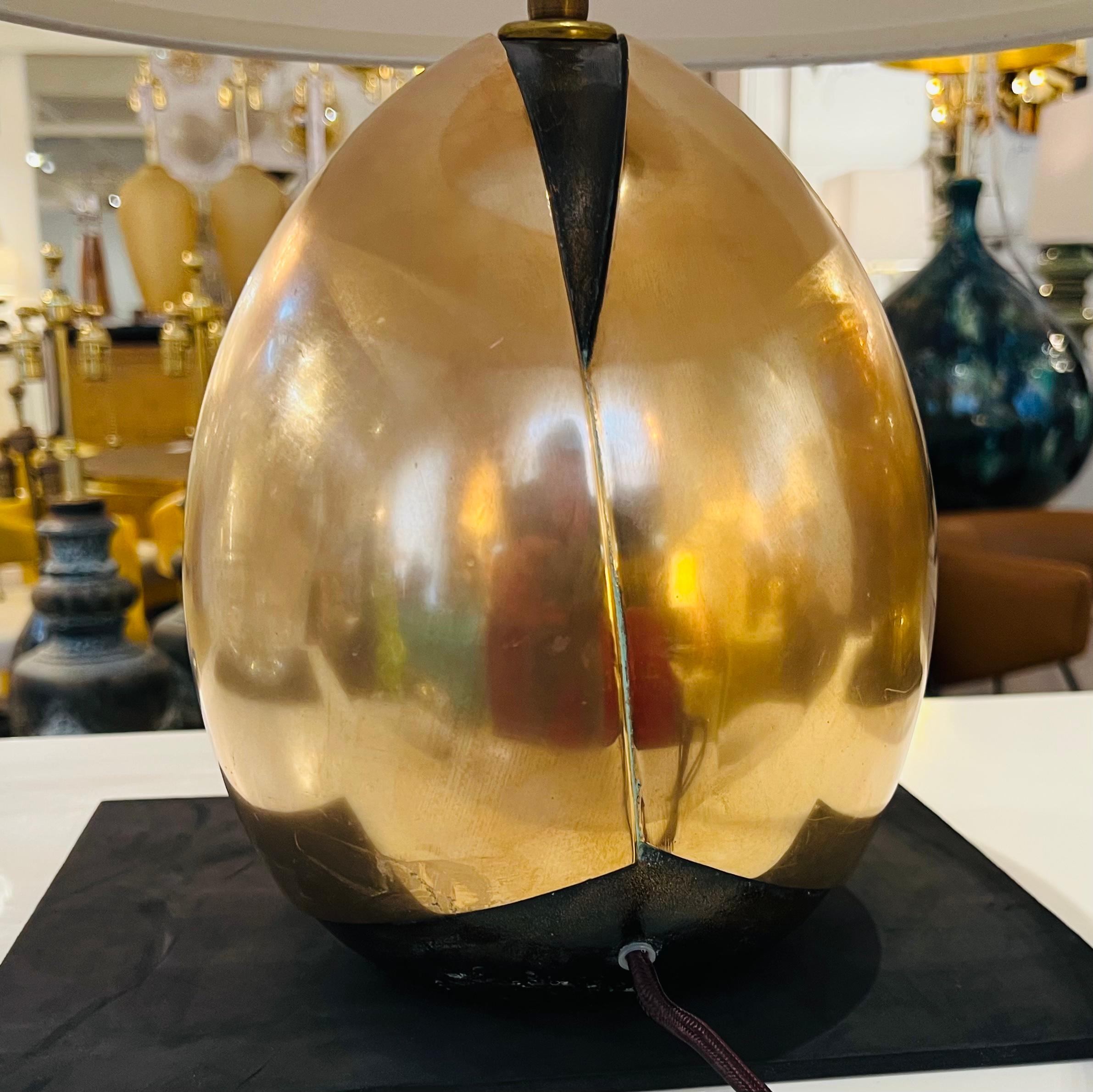 A beautiful sculptural polished and dark Bronze ovoid shaped table lamp by Italian designer, Esa Fedrigolli. Signed. Rewired with an aged brass double socket cluster. Brown cloth cord. Sculpture is 10” High.