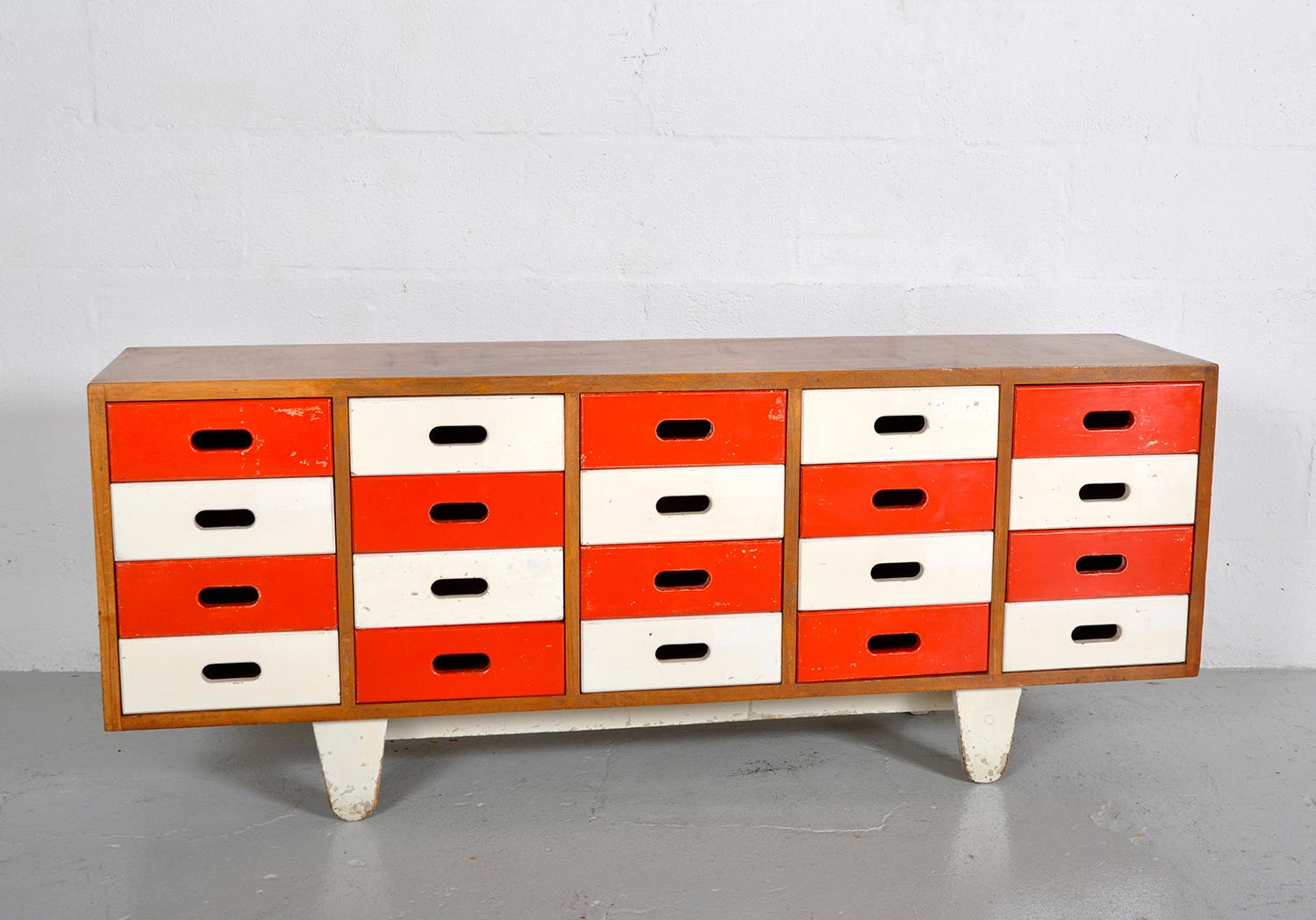 A wonderful bank of drawers designed by James Leonard for Esavian Esa (Educational Supply Association), a leading UK supplier of school furniture. This is a rarely seen 5 x 4 multi-drawer arrangement, as apposed to the most common 4 x 5. 
Sat on