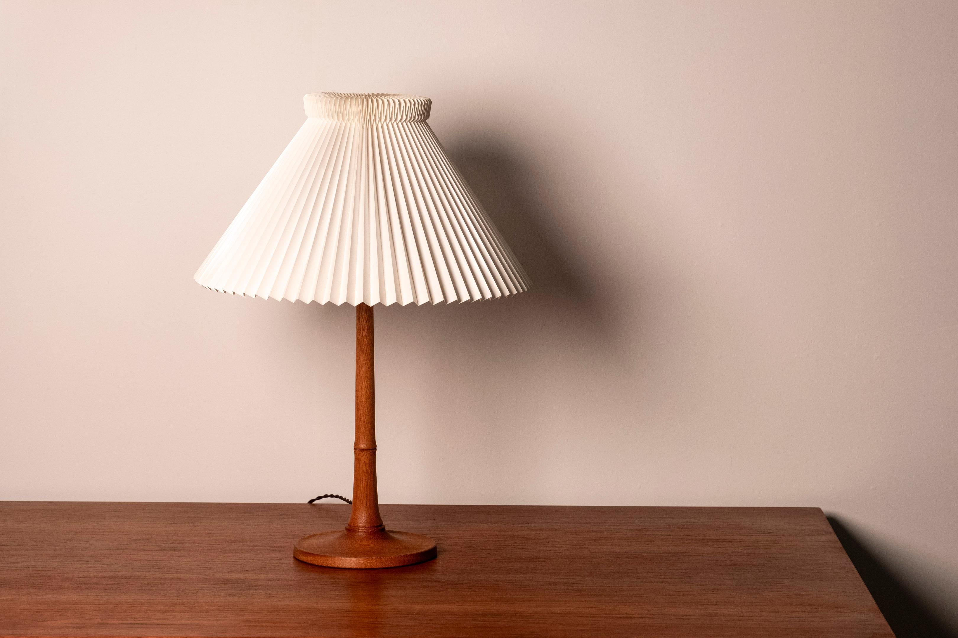 Rare table lamp in teak designed by Esben Klint in 1957 for Le Klint. It has a beautiful wood grain and in very good vintage condition with original paper lampshade. This lamp, Model no. 301, was only in production for a couple of years and is a