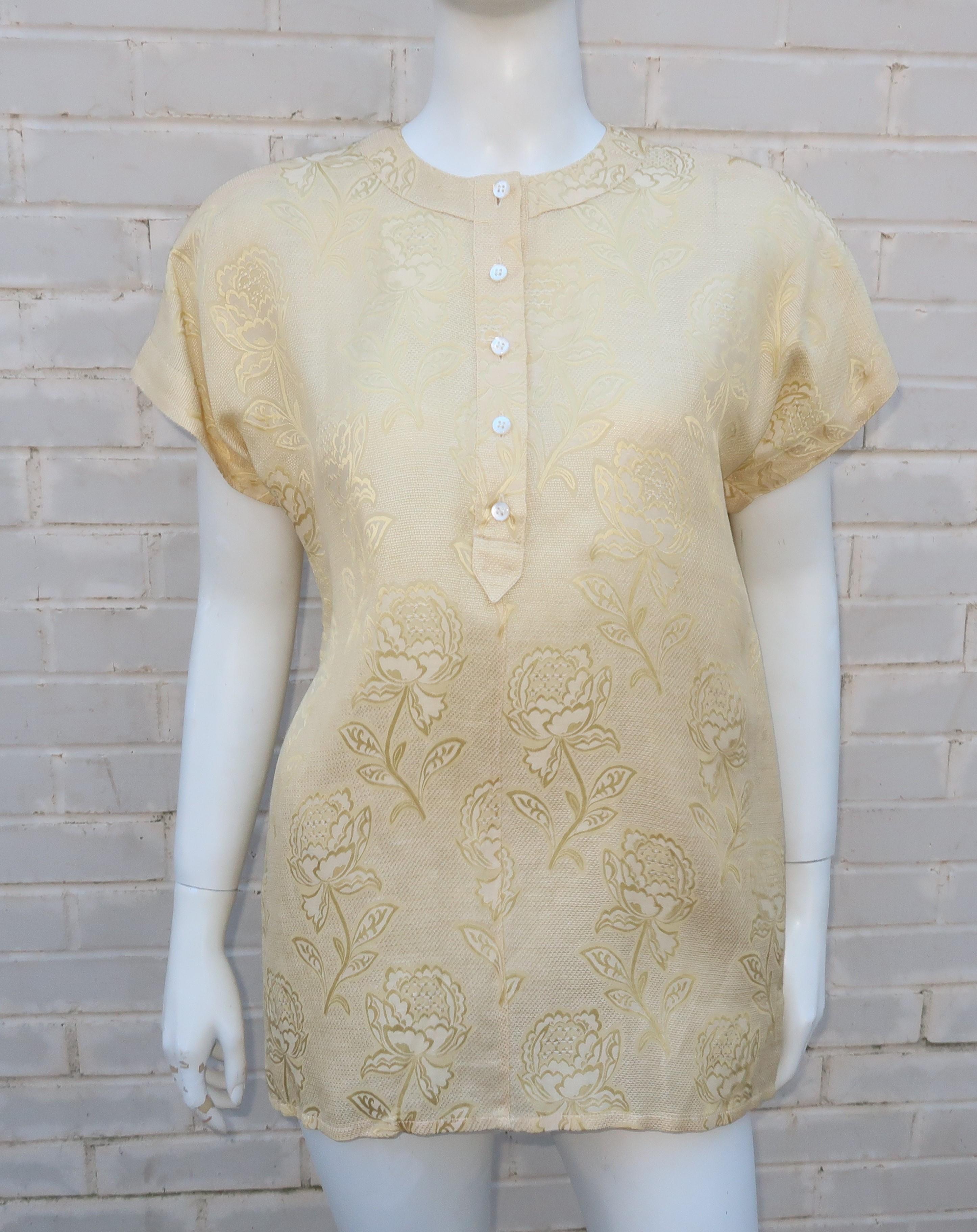 Spring is in the air with this Escada silk and linen blend jacquard top in a pale 'buttery' yellow shade that is the perfect foil for the floral design.  The easy pullover construction is accented by buttons and shaped by a light shoulder pad.  The