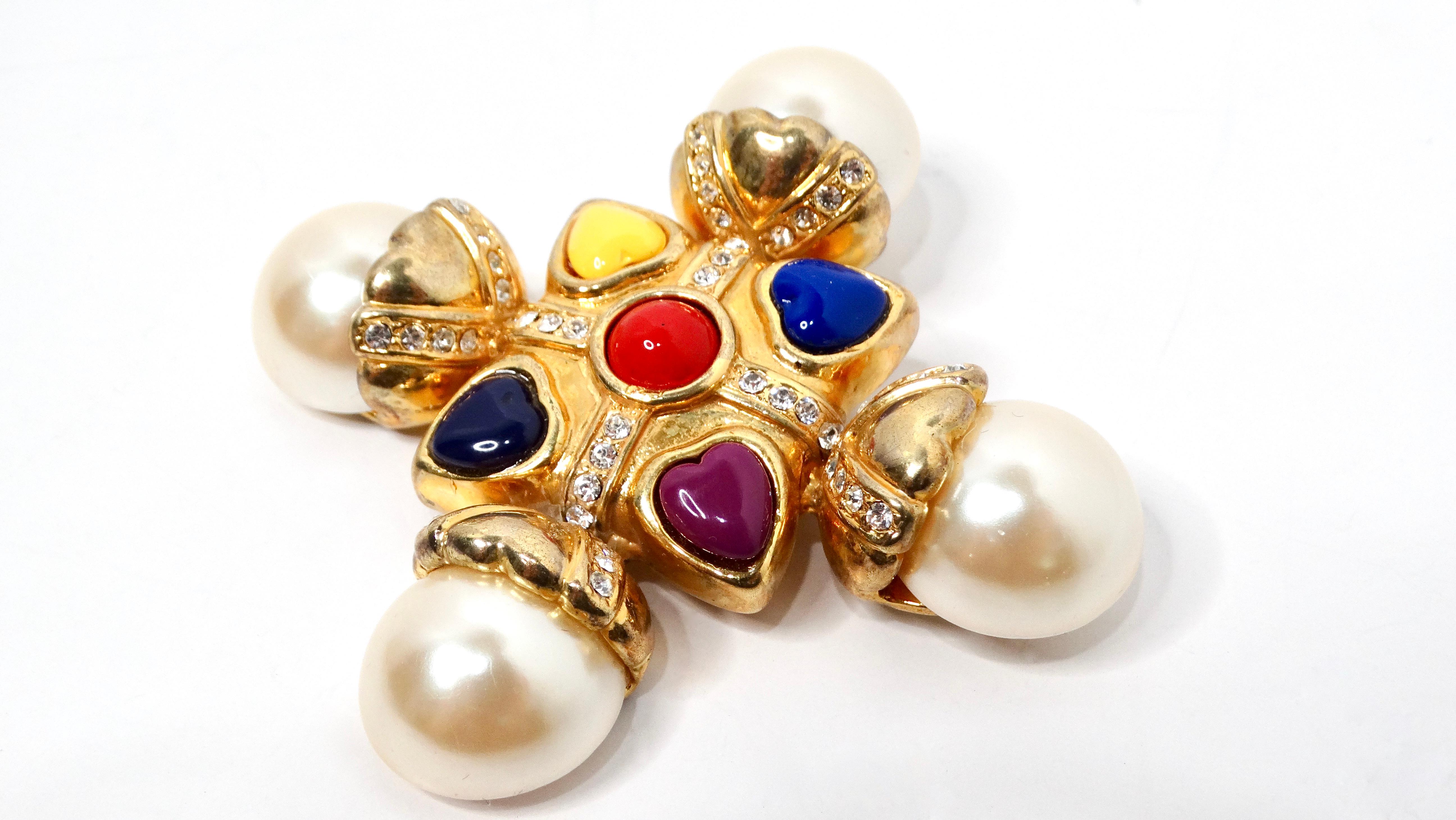 Introducing the stunning Escada 1990s Multicolor Cross Pearl Gold-Tone Brooch, a breathtaking accessory that epitomizes the elegance of vintage fashion while drawing inspiration from iconic Chanel designs. This exquisite costume piece features a