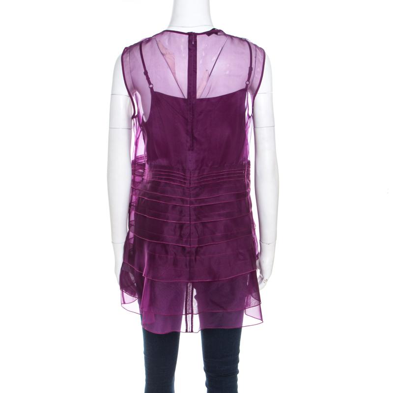 With this Escada creation, beauty is wrapped around in layers and is offered with smooth silk in purple color. This sleeveless top will definitely catch many eyes. Equipped with a back zip closure, it has fine finishing and rich appeal.

Includes: