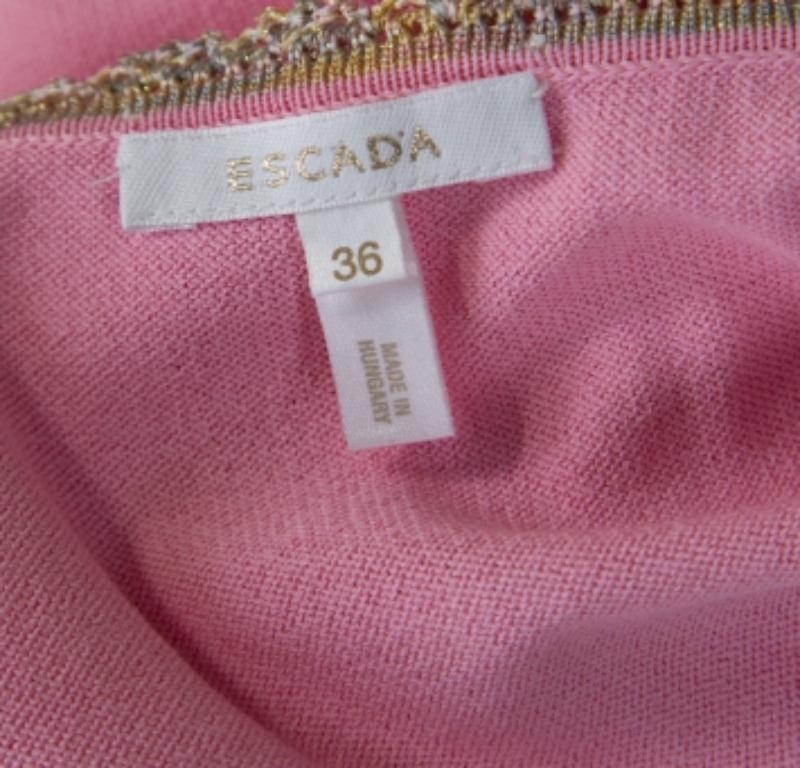 This sleeveless top from Escada is perfect for a casual day out with friends. The baby pink creation is made of a rayon and cotton blend and features a beautiful sequined lace trim. It flaunts a round neckline and can be paired with skirts or