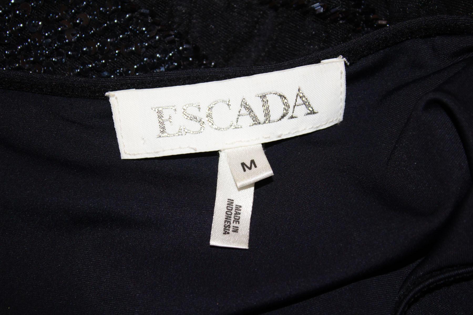 A fun and easy to wear evening top by Escada. The black top has wonderful bead and sequin detail on the front and back on the outer fabric. It has an inner lining fabric and so hangs beautifully. Size M Measurements; Bust up to 40'', length 22''
