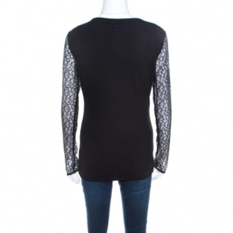 This black piece from Escada entwines femininity and style into one. Tailored in a combination of fine fabrics this features an overlay of lace, sheer long sleeves and beautiful embellishments on the scoop neckline. Be it with skirts or pants, this