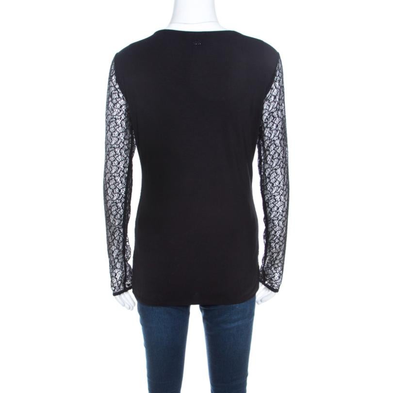 This black piece from Escada entwines femininity and style into one. Tailored in a combination of fine fabrics this features an overlay of lace, sheer long sleeves and beautiful embellishments on the scoop neckline. Be it with skirts or pants, this