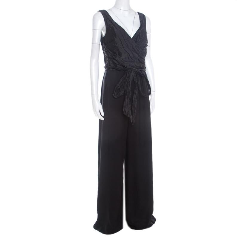 Made from quality fabrics, this black jumpsuit by Escada has been styled with a ruched bodice and a belt at the waist. It is completed with a zip fastening and the brand label. Style this jumpsuit with strappy gold stilettos for a high-fashion