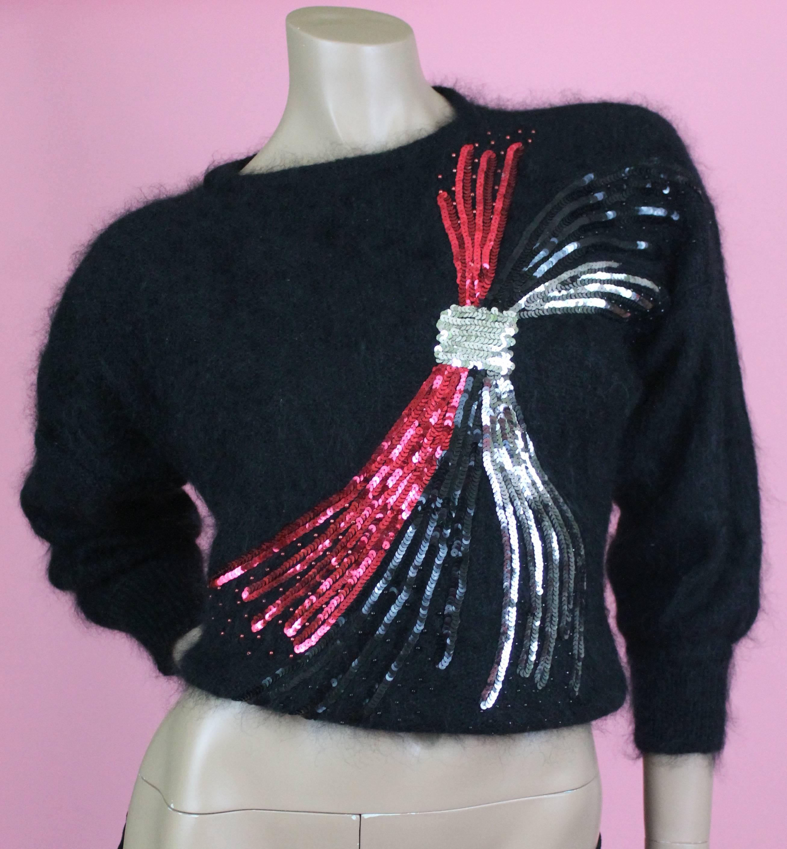 -Adorable Escada mohair blend sweater with tri-colored sequined knot on the chest
-Sweater is sized 34 German, best fitting size US 2-4
-Has a boxy fit, please note that it has velcro strips inside the shoulders for shoulder pads (an 80's