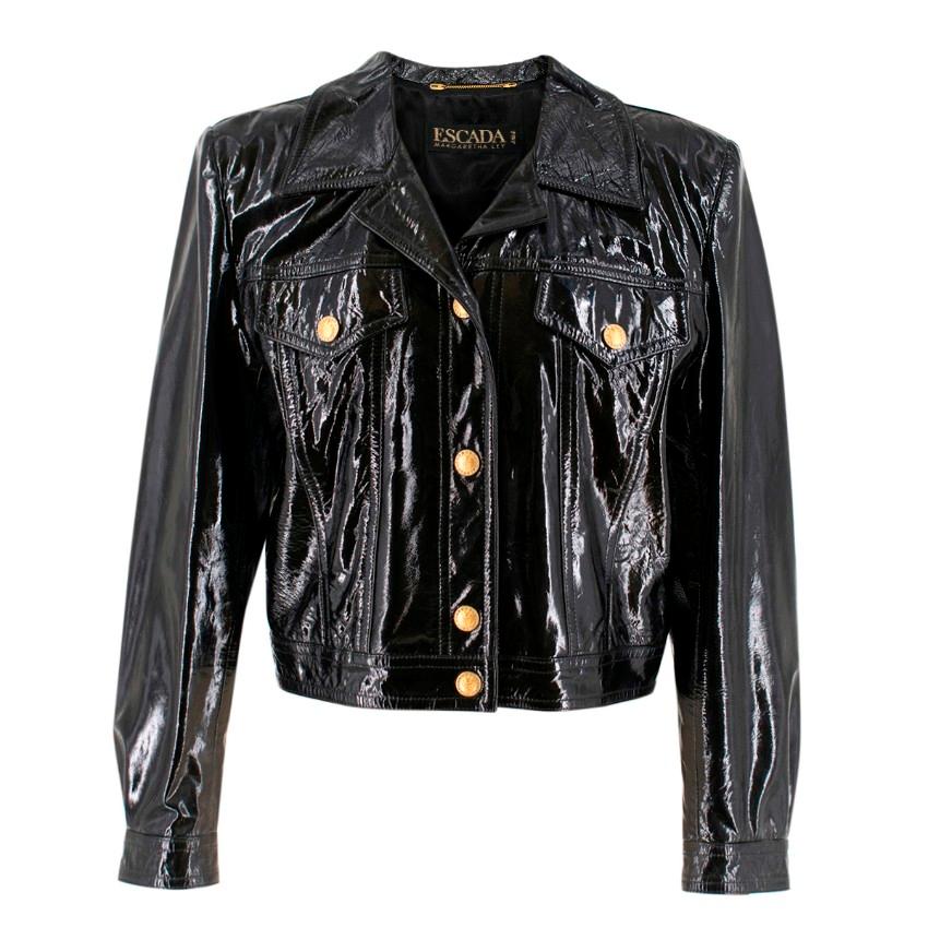 Escada Black Vinyl Jacket

- Black glossy vinyl jacket
- Gold-tone embossed buttons framed with silver rhinestones
- Button fastening
- Regular fit
- Long sleeves with buttoned cuffs
- 2 buttoned bust pockets
- Lined

Please note, these items are