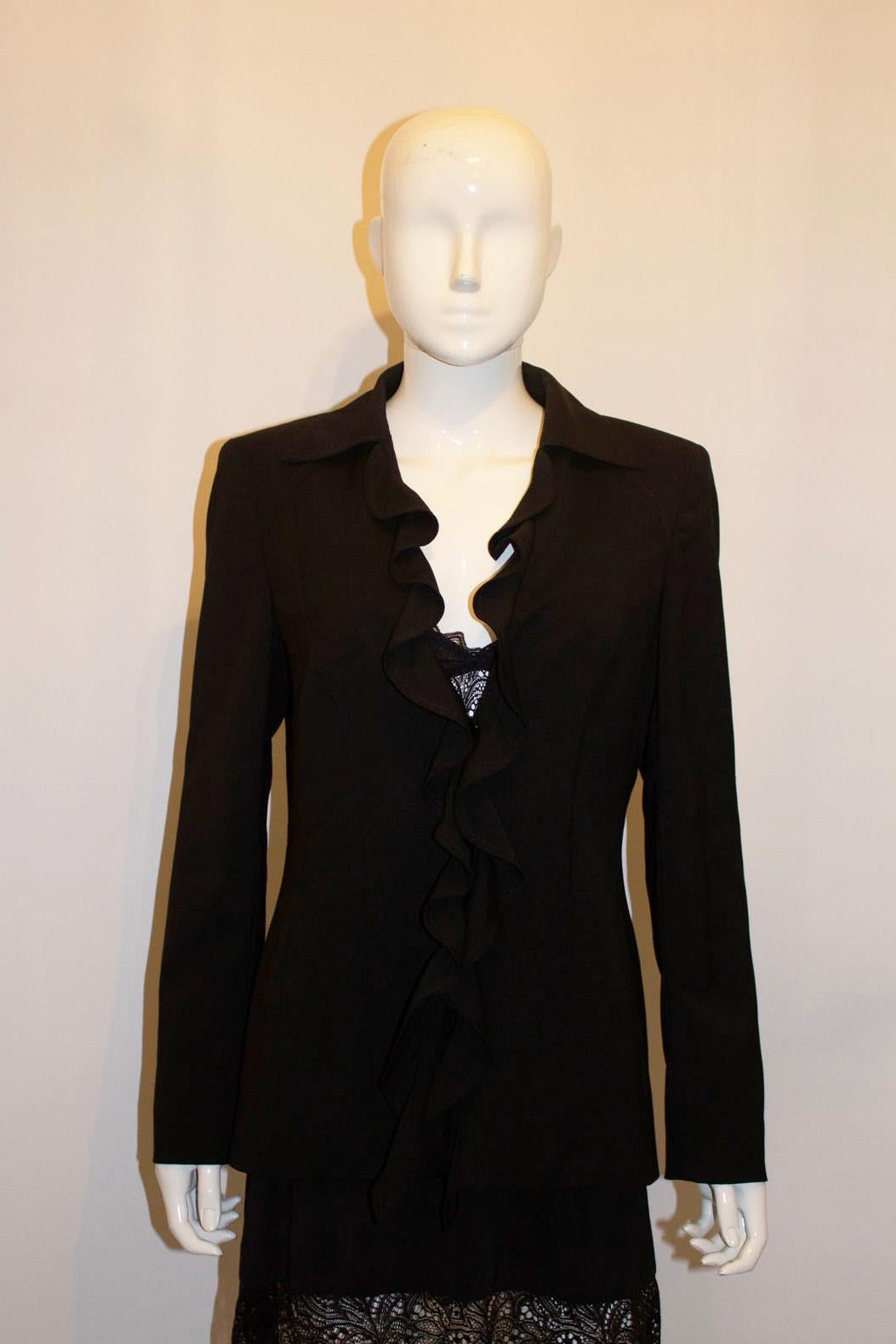 A chic and easy to wear jacket by Escada.  The jacket is in black wool , and has a pocket on either side , a two button fastening , cut away collar with frill detail along the neckline. Measurements ; Bust up to 39'', length 26''
