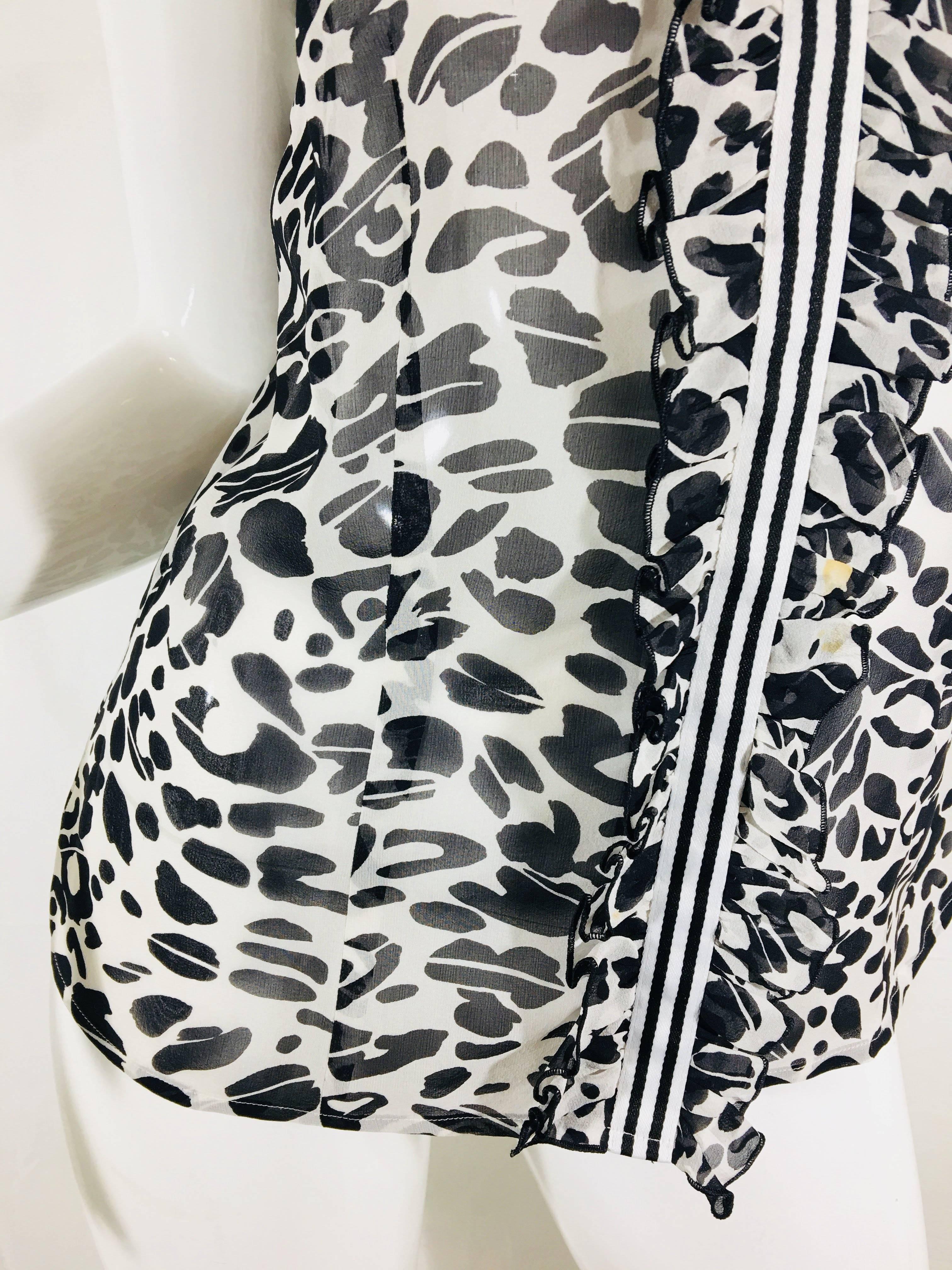 Escada Sleeveless Leopard Print Blouse with Contrasting Striped Ribbon around Collar Down to Bottom Hem.
Please note Small Stain shown in photos.