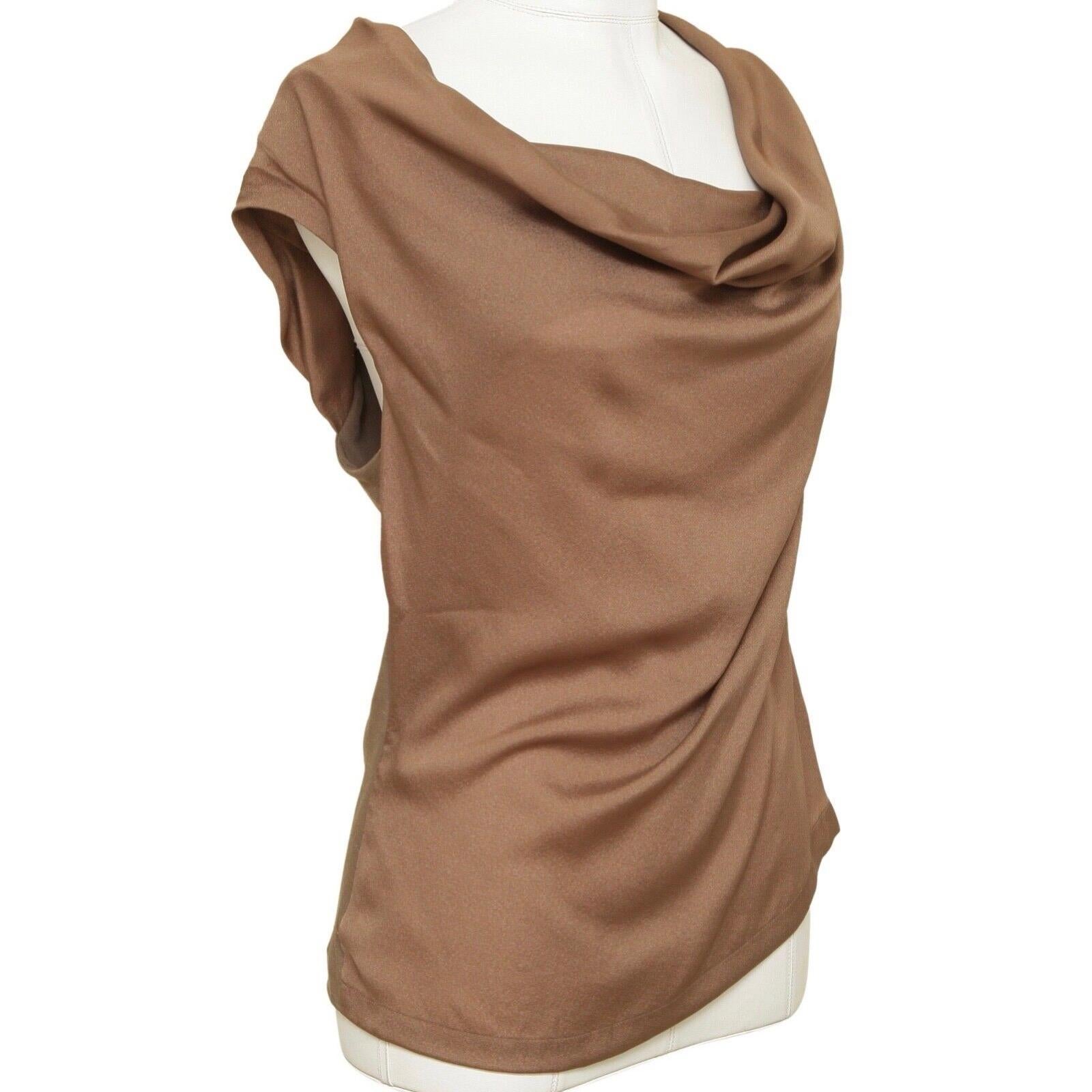 GUARANTEED AUTHENTIC ESCADA BROWN (TOBACCO) SILK BLEND TOP

Retail excluding sales tax $525

Design:
- Comfortable to wear asymmetrical fit cowl neck blouse.
- Cap sleeve.
- Silk front, wool/polyamide v-neck backside.
- Slip on.
- Beautiful,