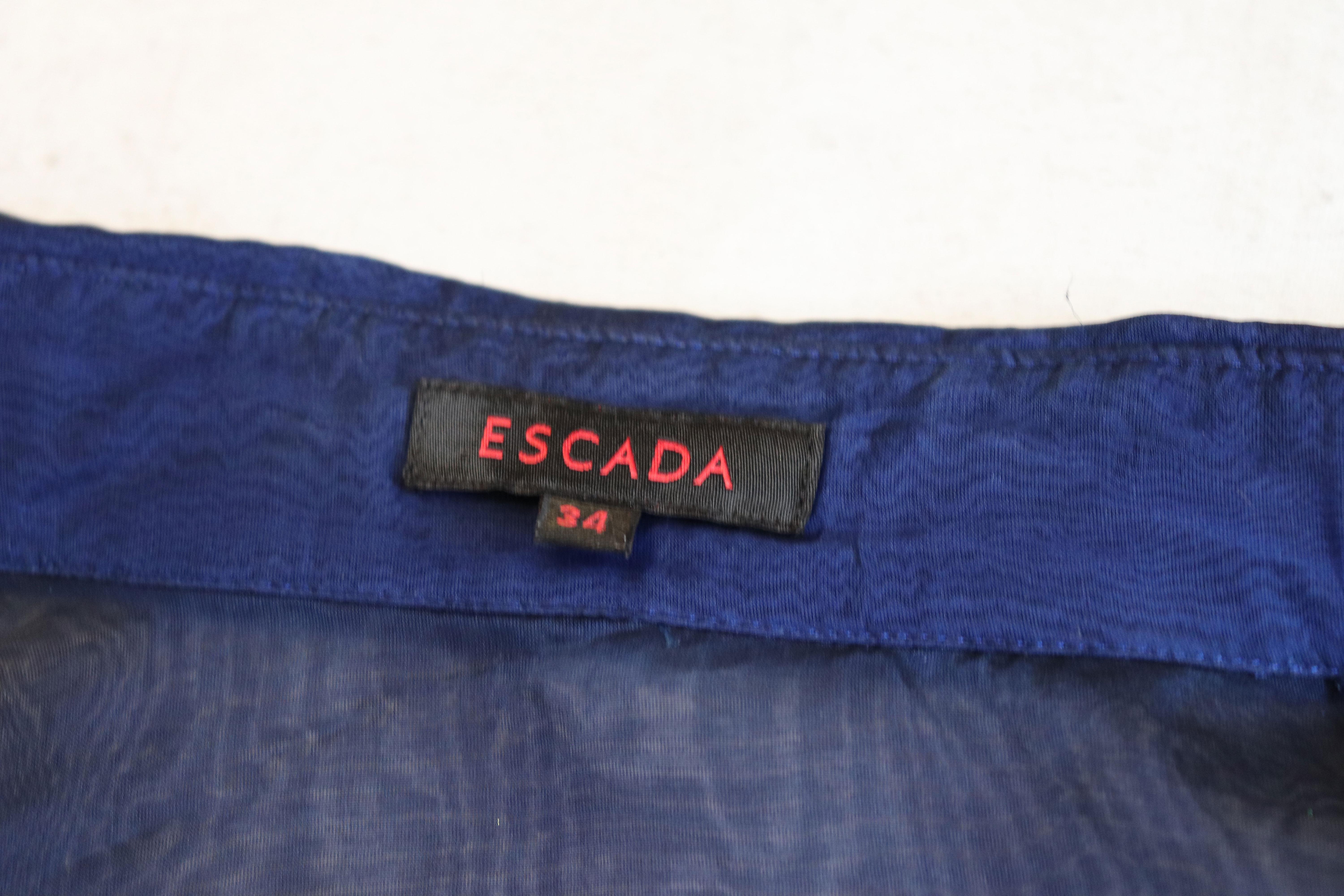 A chic silk shirt by Escada. The shirt has pleats at the front, and singe button cuffs.