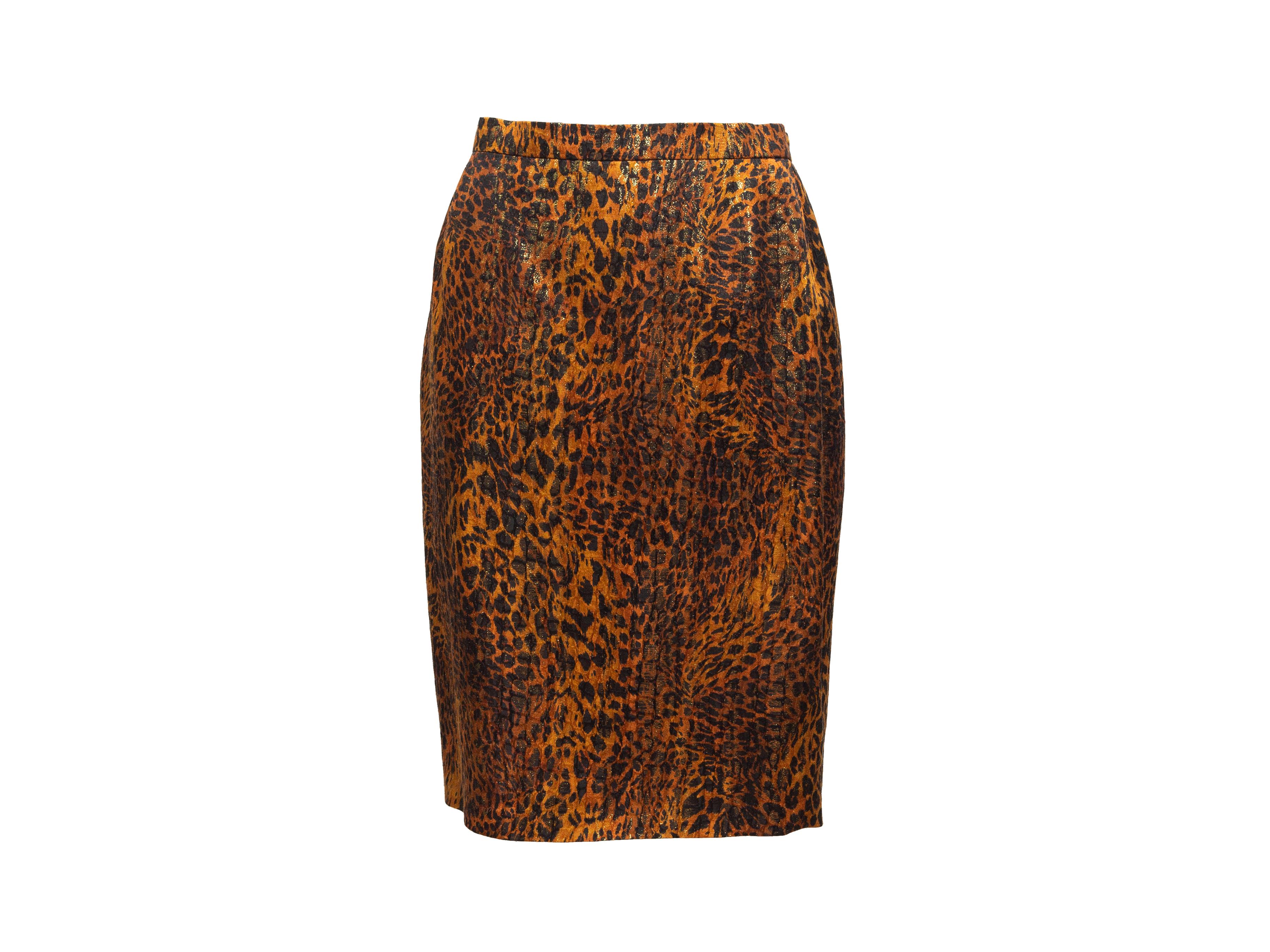 Product details: Vintage brown and black metallic leopard print skirt suit by Escada. Blazer features peaked lapel, dual hip pockets, and gold-tone button closures. Skirt features zip closure. Blazer- 38