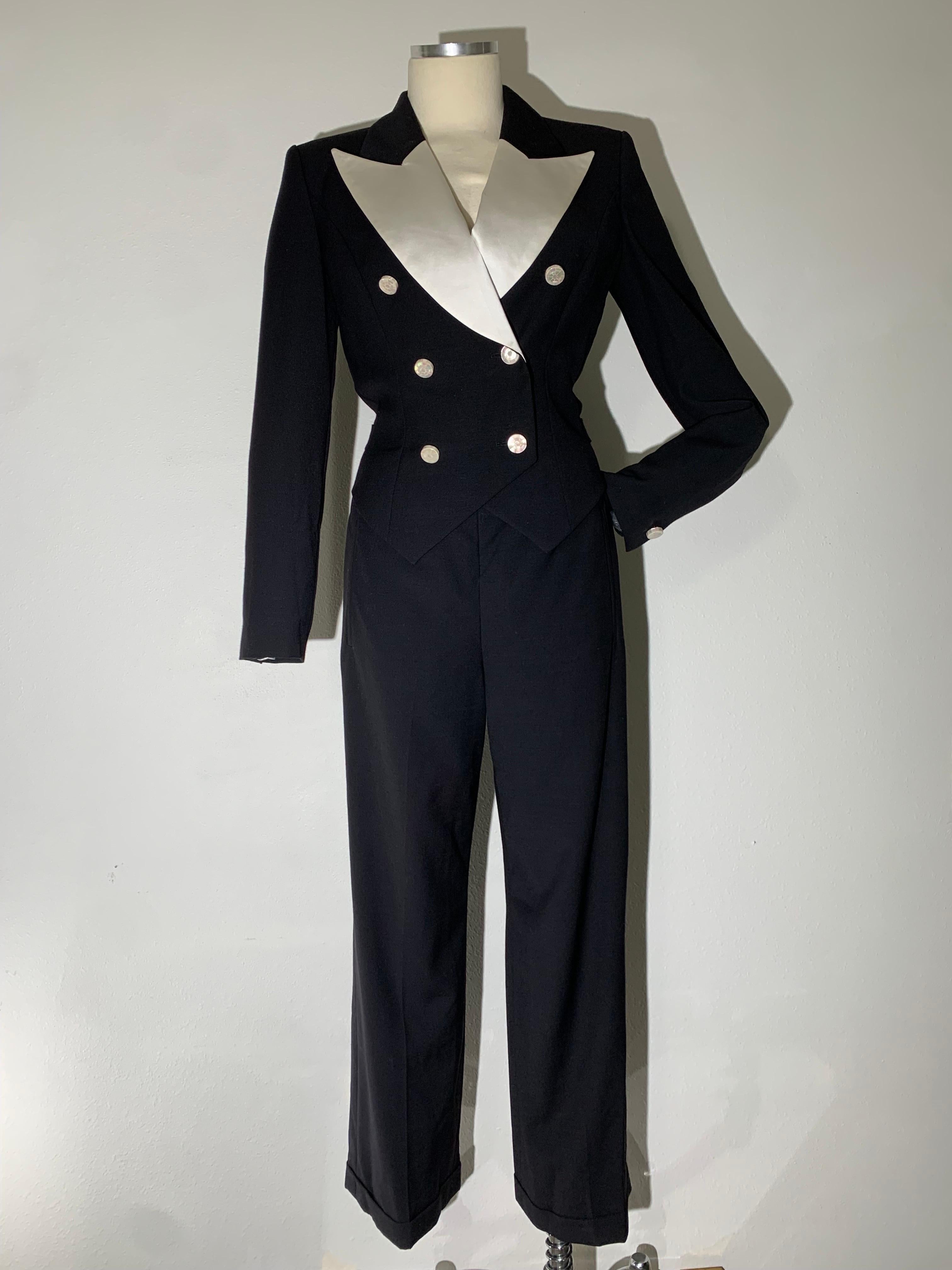 Escada By Margaretha Ley Black Wool Gabardine and White Silk Satin Tuxedo-Style Jumpsuit:  Double breasted, with wide peaked 40s-style lapels, mother of pearl buttons at front and cuffs. Shaped sculpted waist silhouette with a small belt at back for