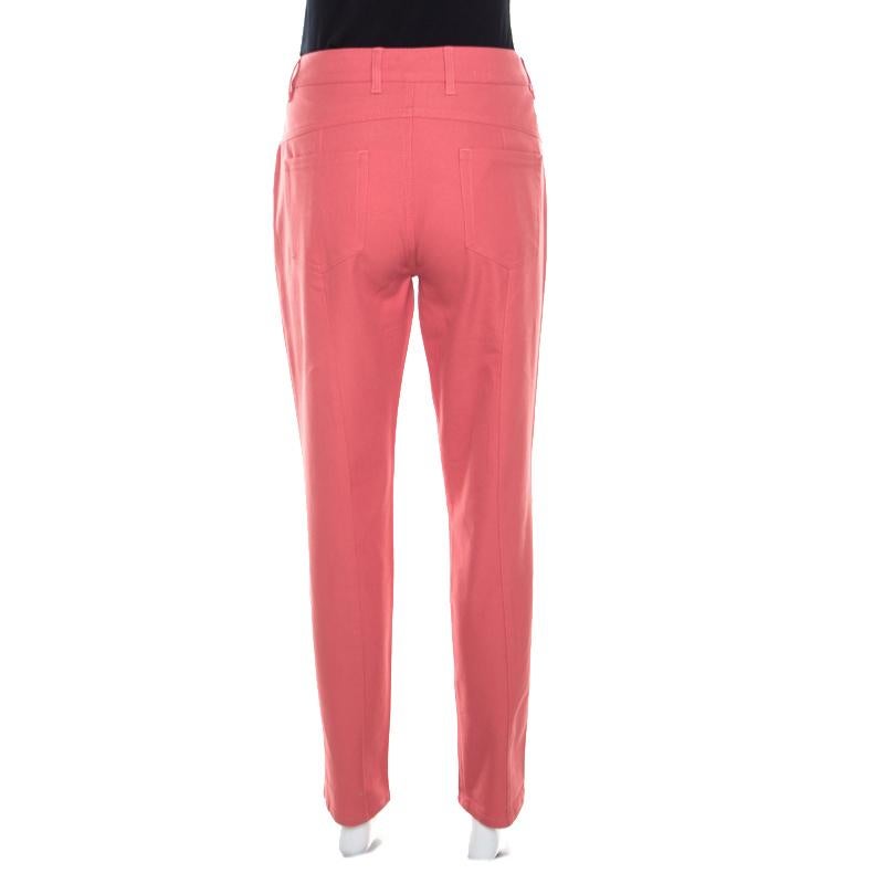 Wear these coral pink jeans from Escada on days when you wish to dress casually. Made of a cotton blend, they've been tailored to offer a straight fit. You must try wearing it with a T-shirt and block heel sandals.

Includes: The Luxury Closet