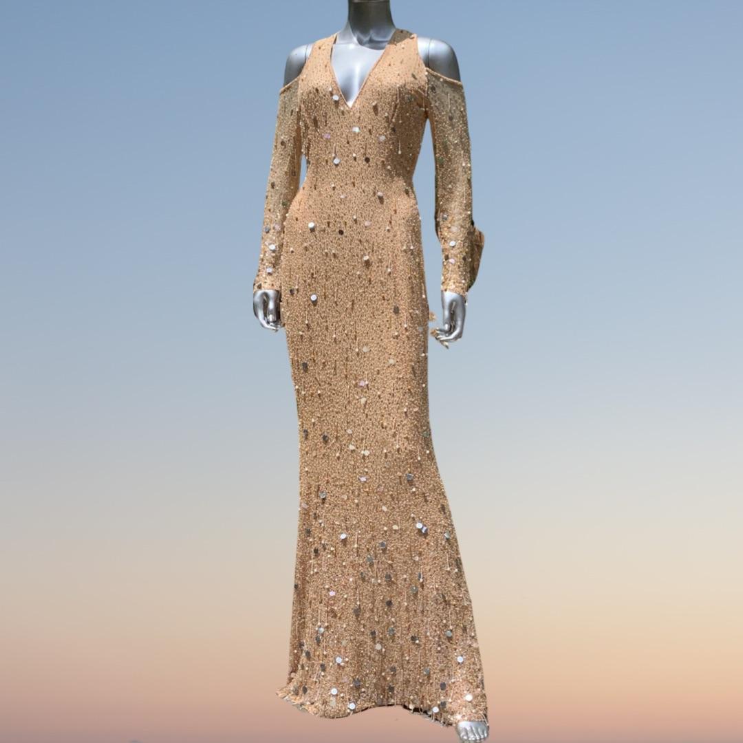 A gown that is a work of art. A couture gown made by Escada, Germany. This sexy, showstopper gown is hand beaded in Sequins, Paillettes, pearls, some dripping, all graduating sparsely at v neck bodice to heavily beaded at hem. Cold Shoulder detail