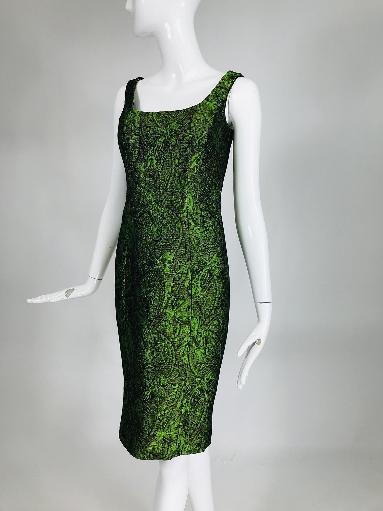 Escada Couture, moss green silk/wool brocade sheath dress. Low scoop neckline, princess seam dress is fitted through the body and tapers to the hem. Beautiful iridescent green brocade with lush dimension. The dress is fully lined in black, the