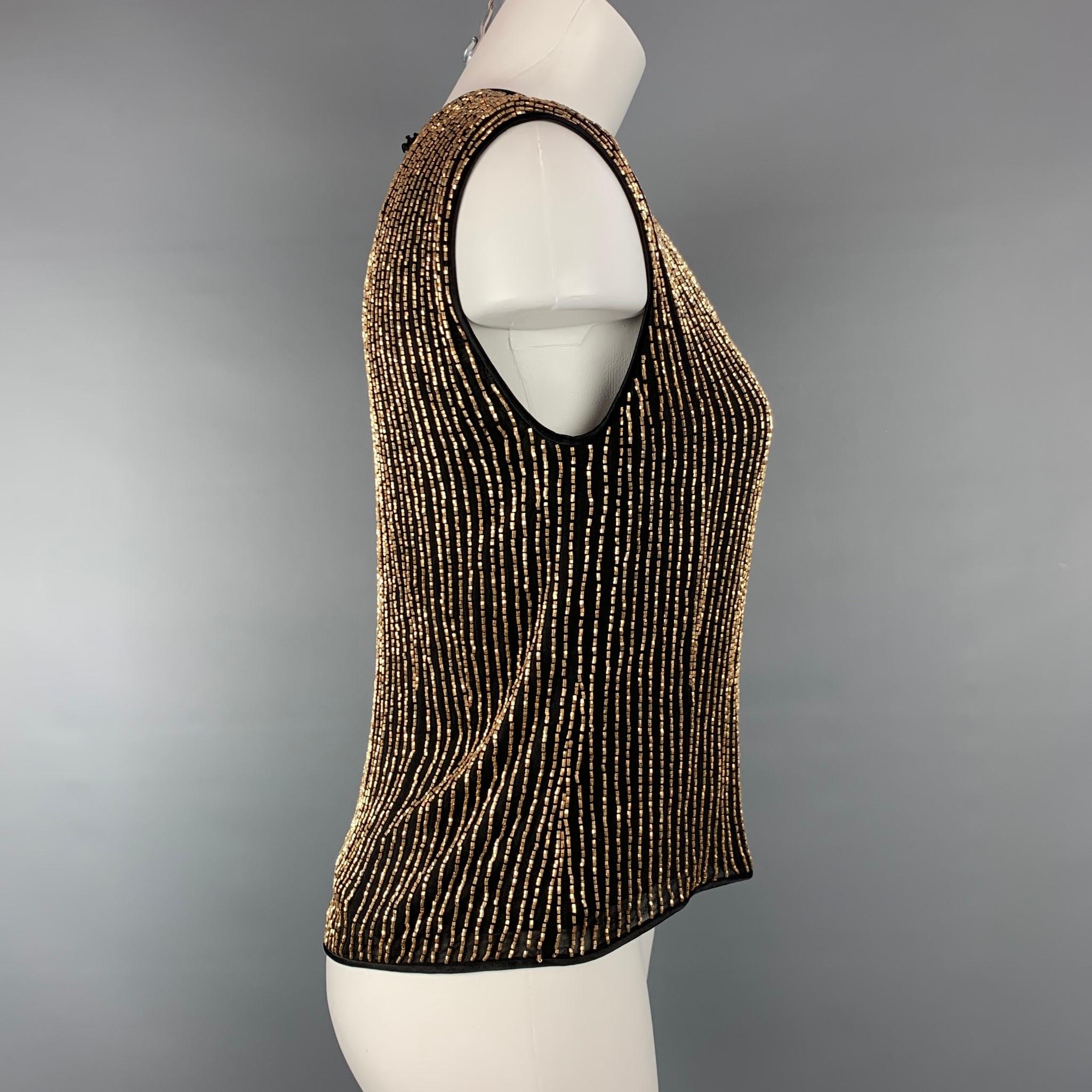 ESCADA COUTURE dress top comes in a black silk with a gold beaded design featuring a sleeveless style and a back single button closure. 

Very Good Pre-Owned Condition.
Marked: 36

Measurements:

Shoulder: 15 in.
Bust: 33 in.
Length: 20.5 in. 