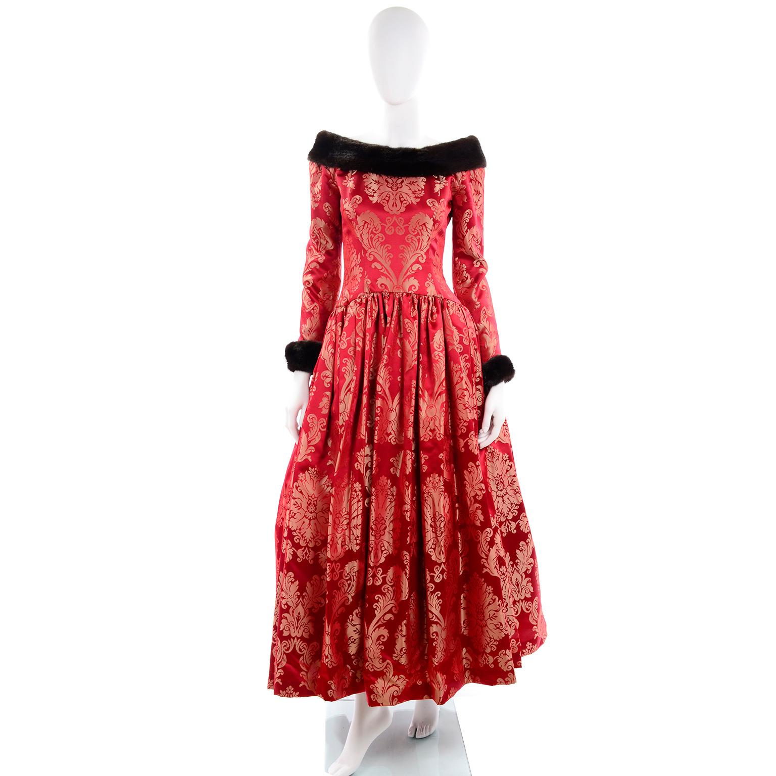 This sensational vintage ball gown from Escada Couture is in a luxe red jacquard and is trimmed in mink. The fur cuffs on the gorgeous evening dress are removable and the sleeves have zippers and button closures. There is a zipper down the center