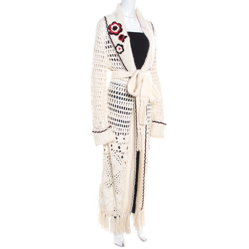 This lovely cardigan is designed by Escada in a combination of fine fabrics. It features a multicolor floral applique and a belt tie-up at the front. Designed with long sleeves, the cream creation comes with scalloped detailing and tassel edge. It