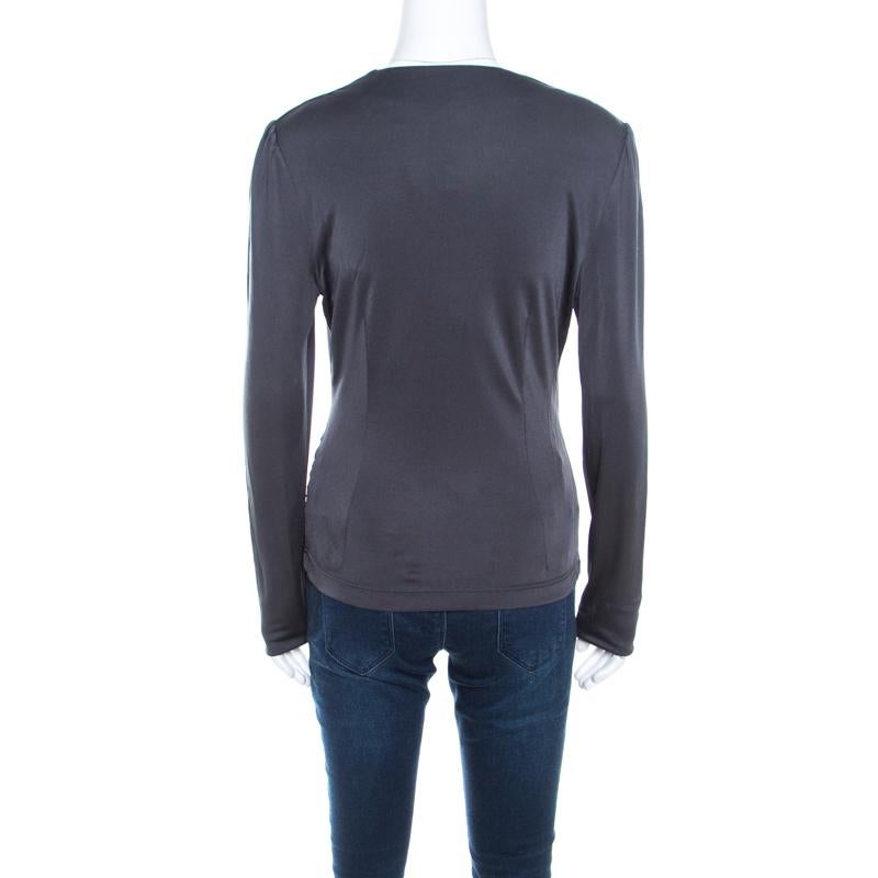 You must get your hands on this lovely creation from Escada. The grey top is knit perfectly and it has long sleeves and a crossover front. It can be teamed with jeans or trousers and a pair of glossy pumps.

Includes: The Luxury Closet Packaging,