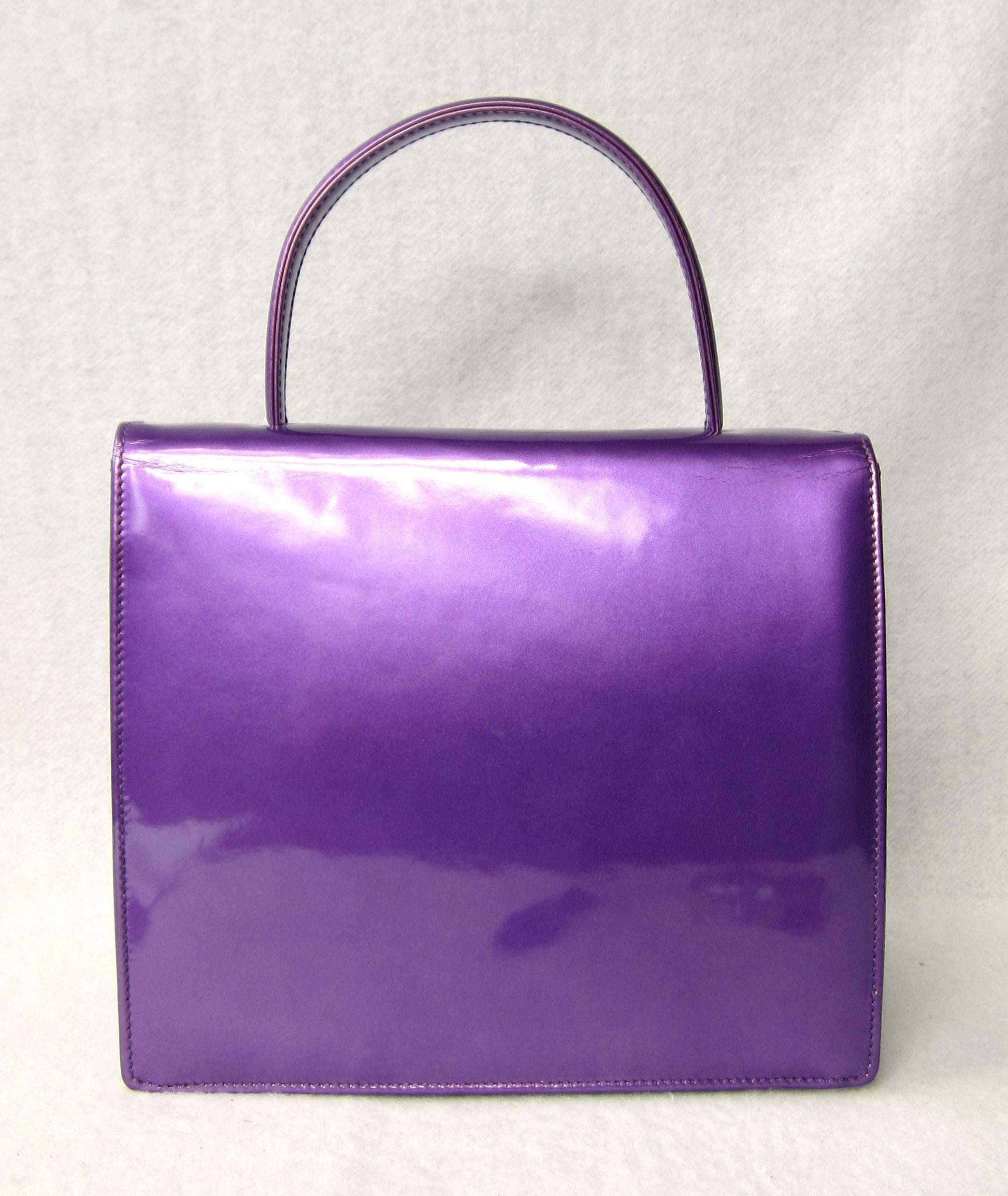 Another Escada hand bag in a stunning Purple purchased in the late 1980s early 1990s stored away, never used with Suede interior. Measuring 8.75 in. wide x 7.75 in. H x 2.75 in. deep. One main compartment and a small compartment inside. This is out