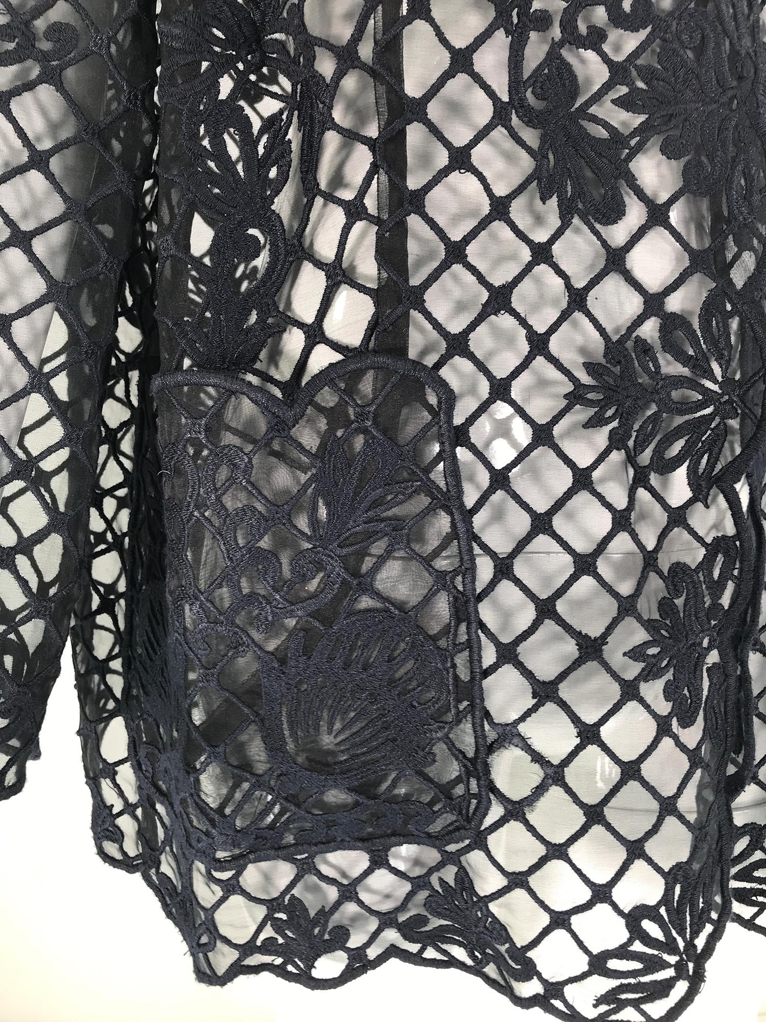 Escada heavily embroidered black silk organza unlined jacket with hip patch pockets. Beautiful lattice embroidery with flowers scattered throughout. The jacket facings are finished in embroidered scalloped edging. The open front jacket is unlined,