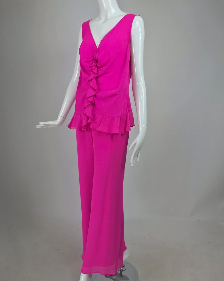 Escada Hot Pink Silk Crepe Pant Set size 44. Sleeveless top has a plunge neckline with a vertical ruffle at the center front, the top is draped along the ruffle seam. There is a ruffle hem. Closes at the side with a zipper, unlined.  The Matching
