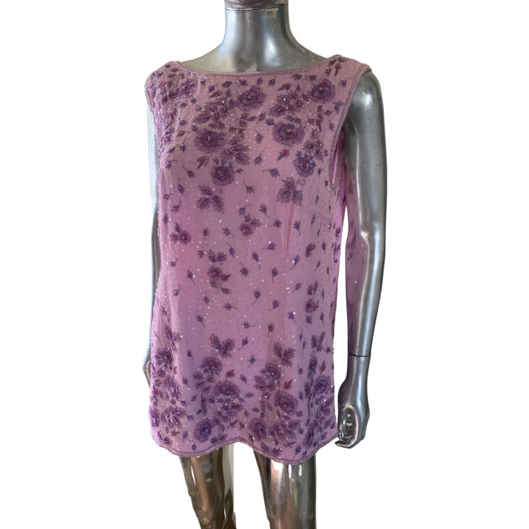 This lilac silk tunic by Escada is exquisite. Sleeveless with deep V back. The very intricate beating and embroidery frame the neckline and hem of the blouse in the front and the back. Brand tag, size tag  and country of origin tag removed. (Found