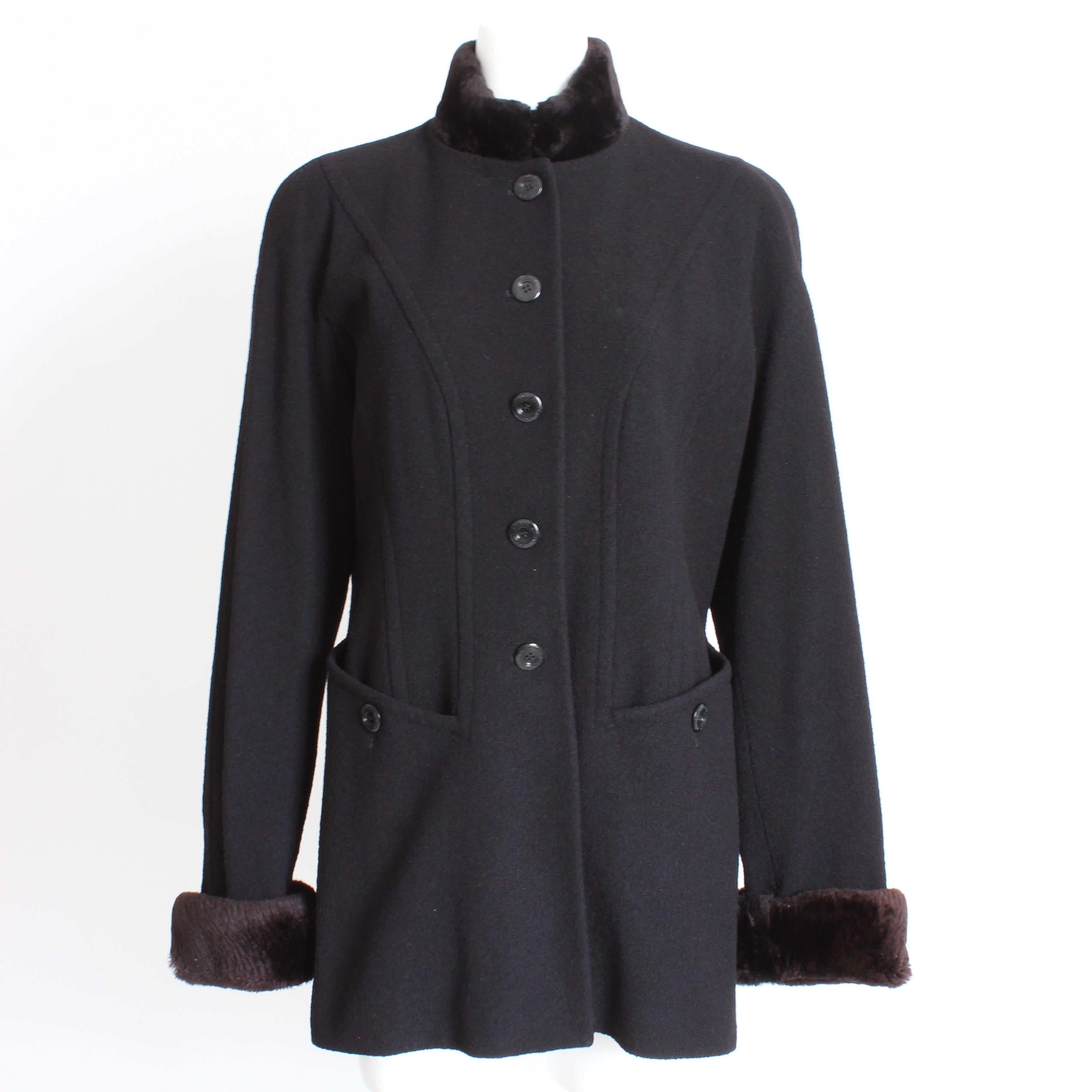 Authentic, preowned, vintage Escada jacket or short coat, likely made in the 1990s. Made from black wool blend fabric, it features a removable brown sheared beaver fur trim! It fastens with logo embossed buttons and features a hook/eye closure under