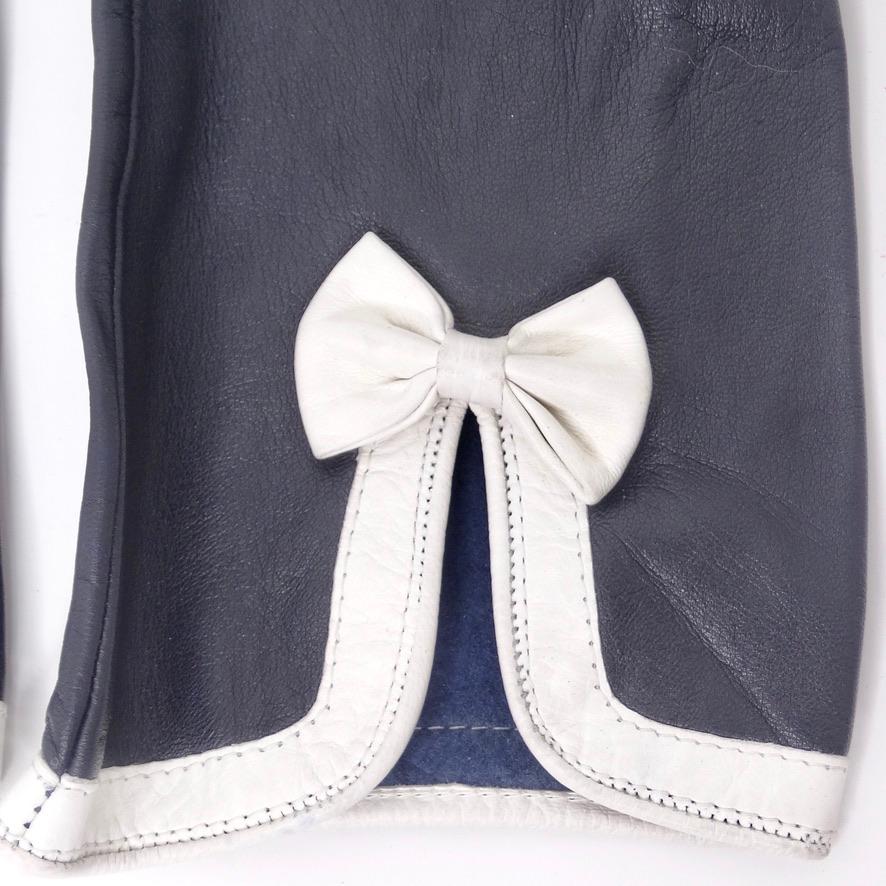 Get your hands on these adorable vintage Esacada black leather gloves! The classic black leather glove is elevated with a fun feminine touch with this adorable white bow motif at the center. This is such a timeless and elegant accessory that will