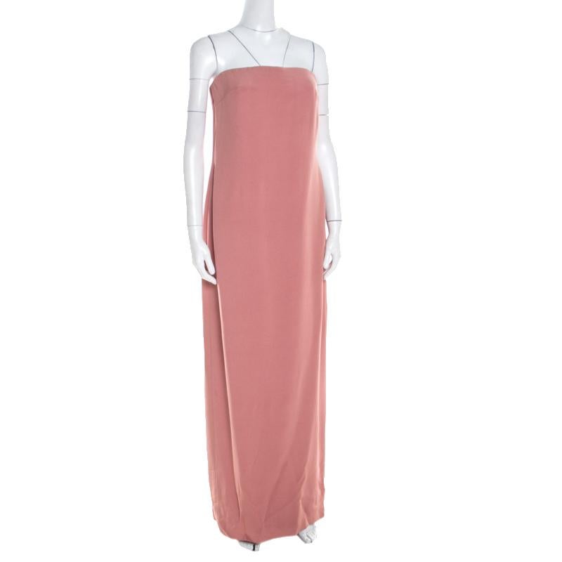 Look your stylish best in this litchi pink gown from the house of Escada. Tailored beautifully from silk, the gown is strapless and it has a lovely asymmetric hemline. A pair of silver sandals and a matching clutch will complete your