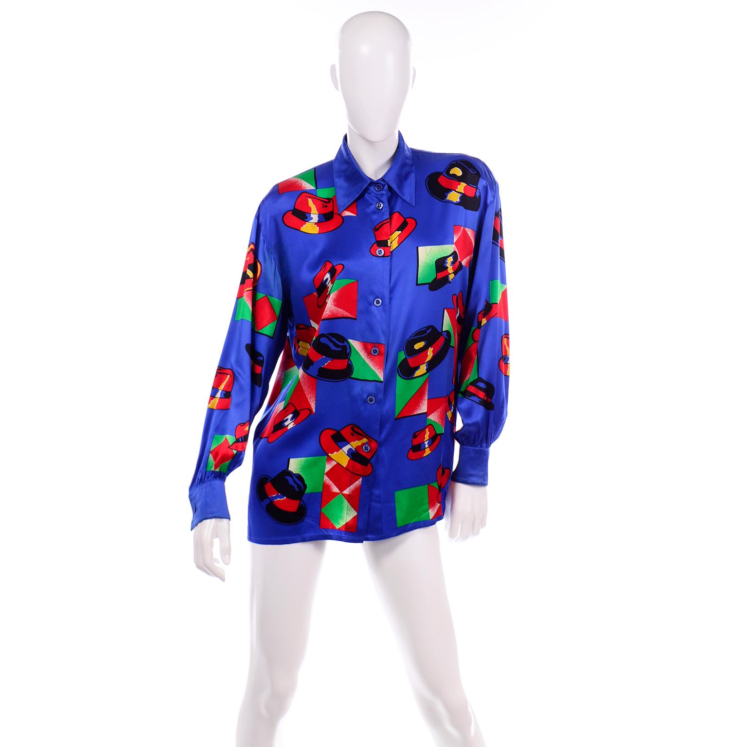 This is such a fun vintage Escada by Margaretha Ley silk blouse in blue with a great black and red fedora hat print with abstract gradient squares of green and red. The style resembles the bold illustrations in a comic book. This blouse buttons down