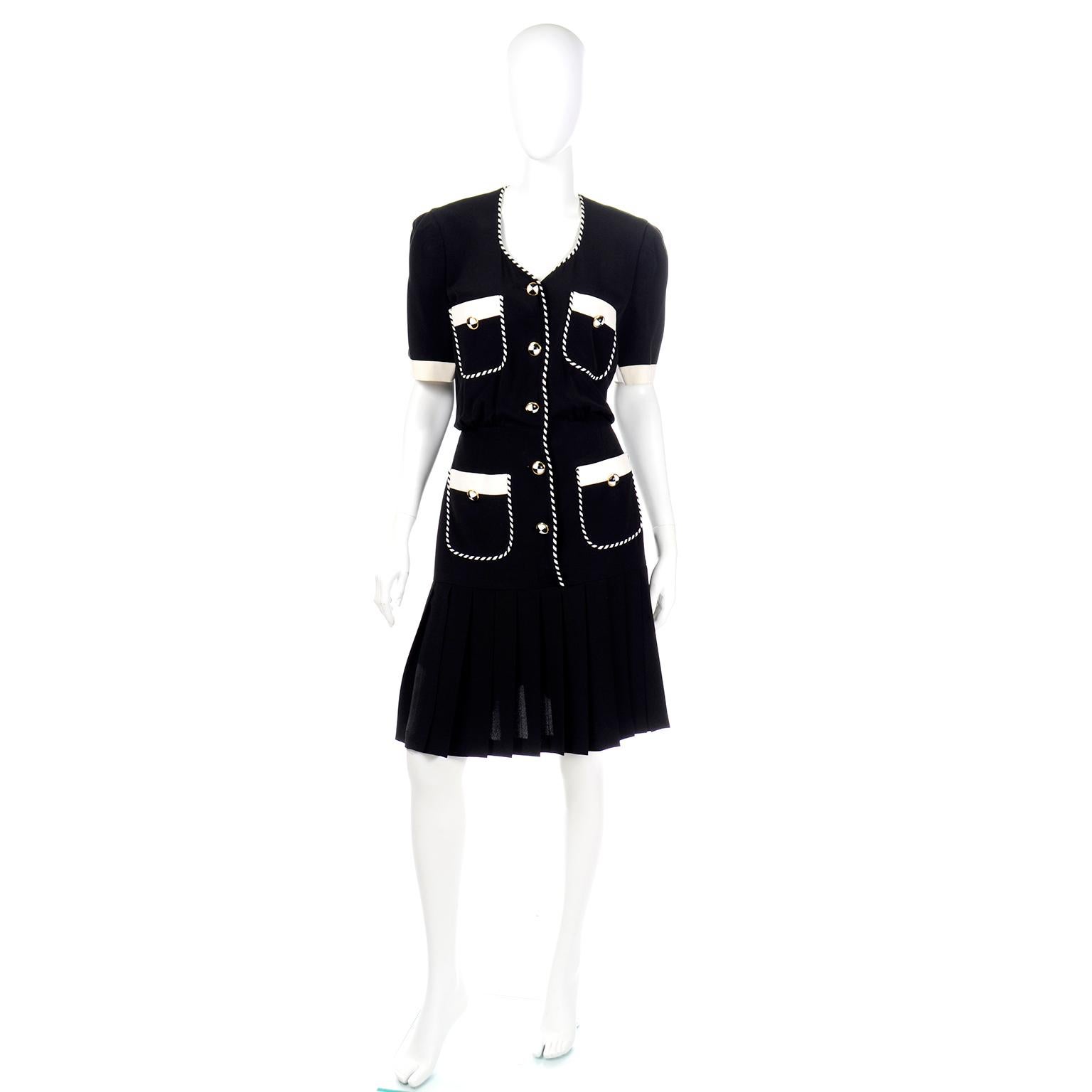 This is a really fun vintage Margaretha Ley for Escada black short sleeve dress with ivory trim and black and white striped piping.  The lower portion of skirt is beautifully pleated and the waist is gently gathered. We love Escada buttons and these
