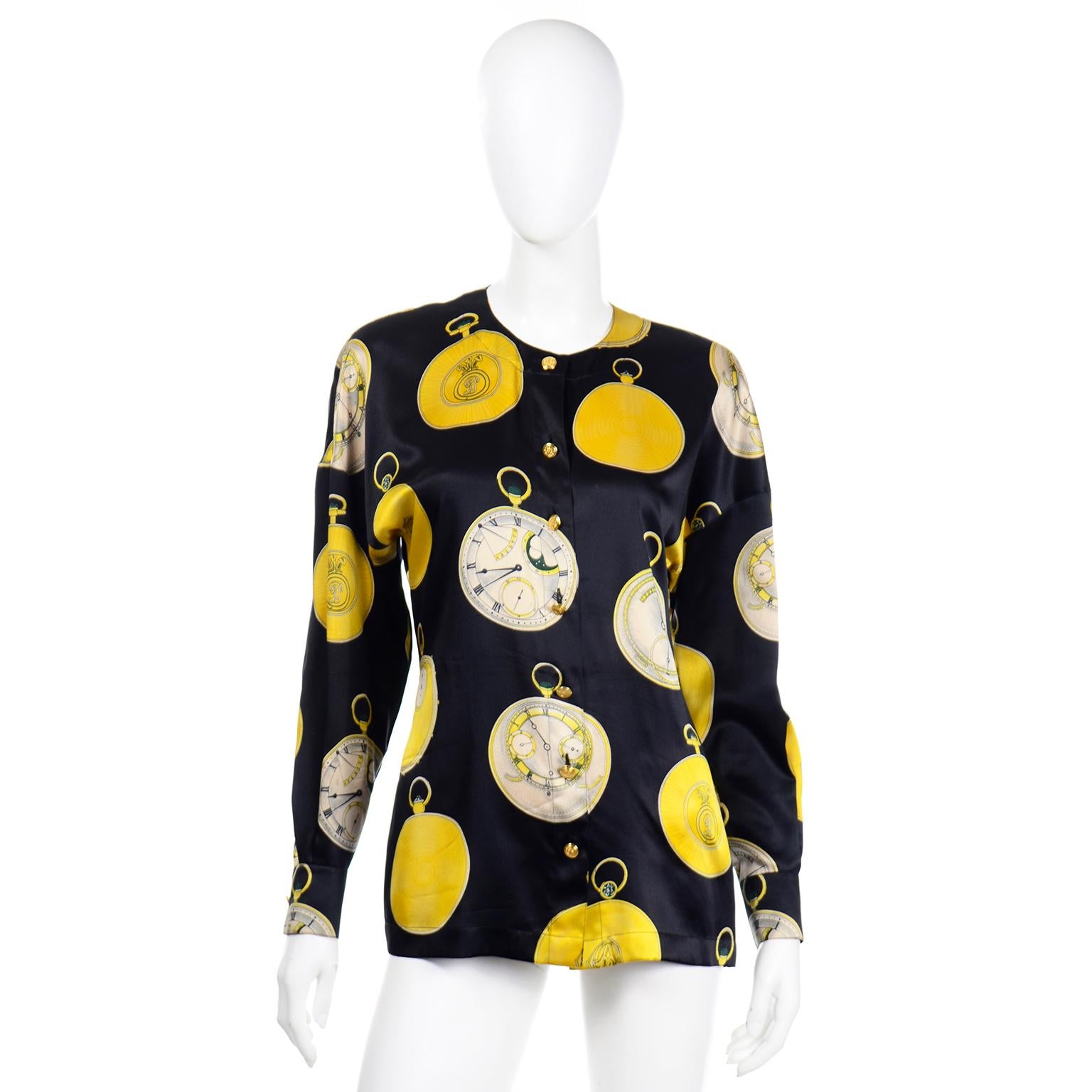 This is a really fun vintage Escada novelty clock print silk blouse that is deadstock, with its original tags still attached!  The fabric is a midnight blue with bright yellow and blue/grey details on the oversized clocks. There are beautiful