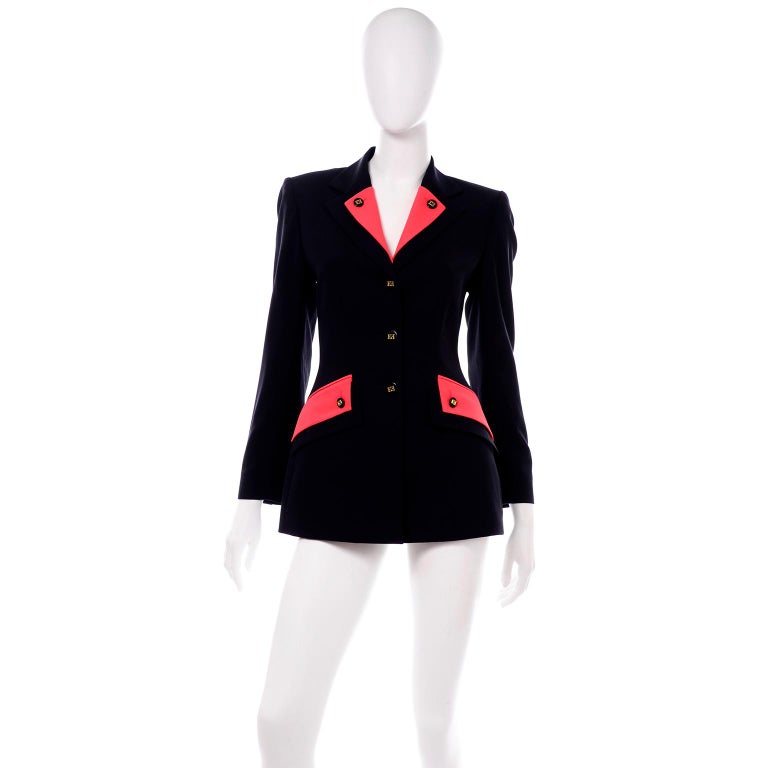 This vintage Escada by Margaretha Ley  jacket is an elevated version of the classic navy blue blazer. We love the pop of bright red seen on the double lapel and pockets. This blazer has a double notch collar that is navy and a shorter version that