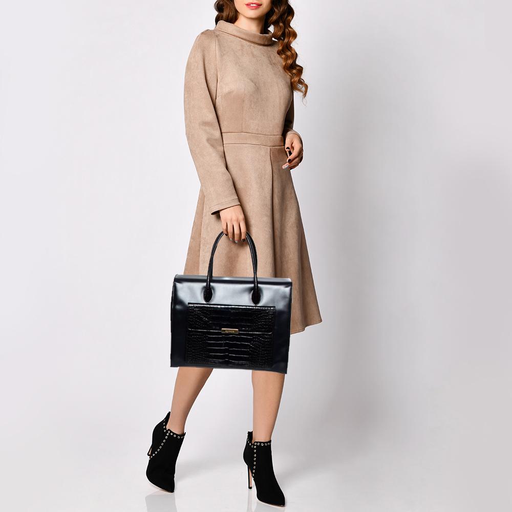 This elegant tote from Escada is ideal for everyday use. Crafted from blue leather, the bag has a front croc-embossed flap pocket and two handles. The top opens to a spacious interior that is perfectly sized to hold all your necessities.

Includes: