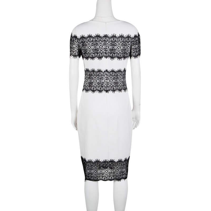 Nothing says glamour as well as the perfect combination of black on white as you can easily see with the Escada Monochrome Scallop Lace Panel Detail Short Sleeve Dress. The stunning white body is complemented by a very detailed black lace detailing