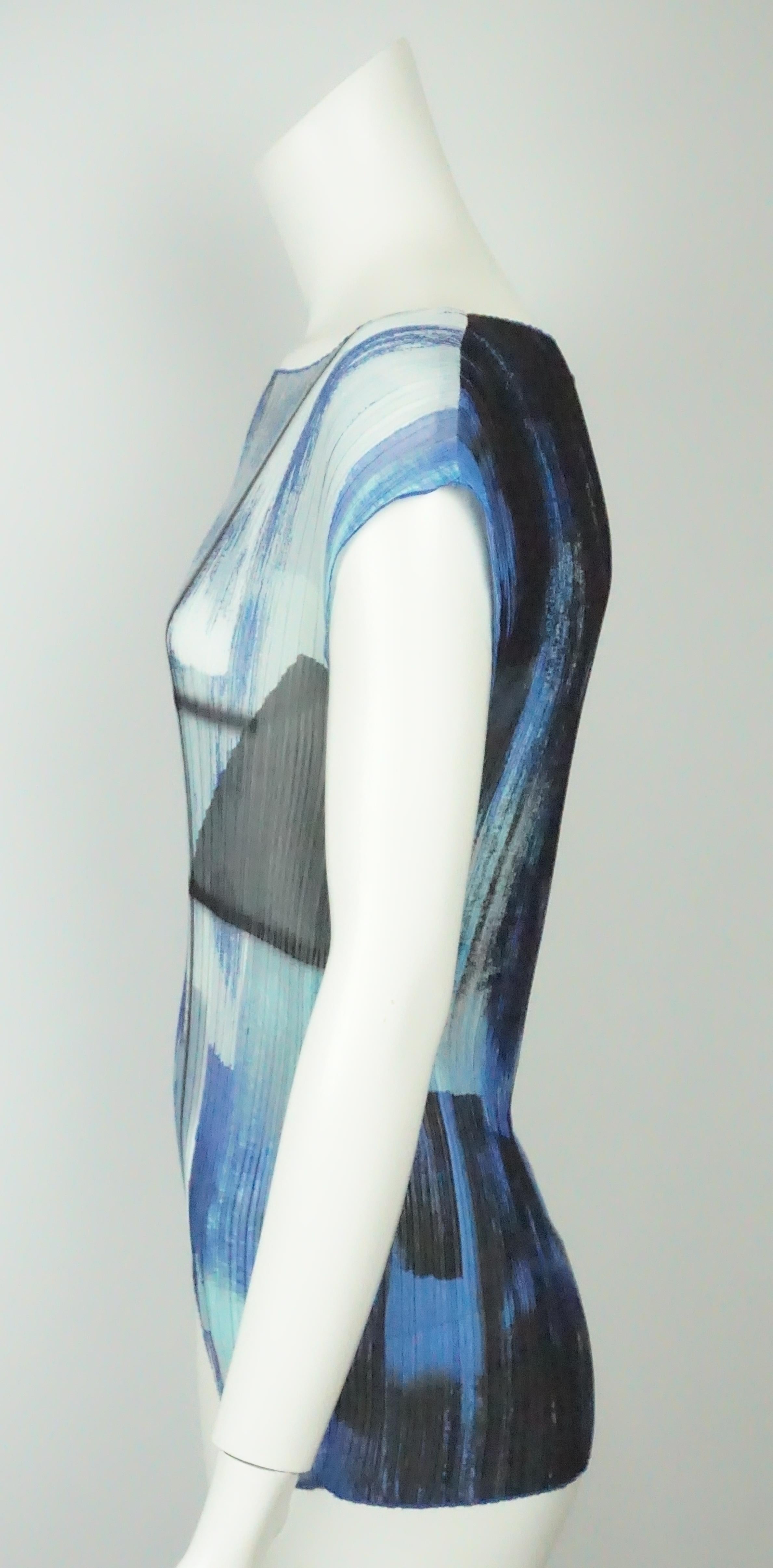 Escada Multi Blue Silk Pleated Sleeveless Top - 36   This beautiful Escada top is in excellent condition. It is completely made of polyester and is sleeveless. There is a round neckline and has blue trimming throughout. There are pleats that make up
