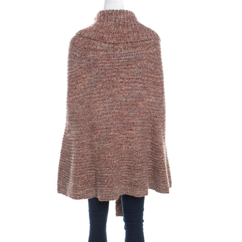 Create an ultra-chic look that is sure to stand out with this Escada cape. Constructed in a multicolored blend of alpaca, wool and cashmere, this jacket is adorned chunky knit pattern all over and features a turtle neckline. This amazingly, feminine