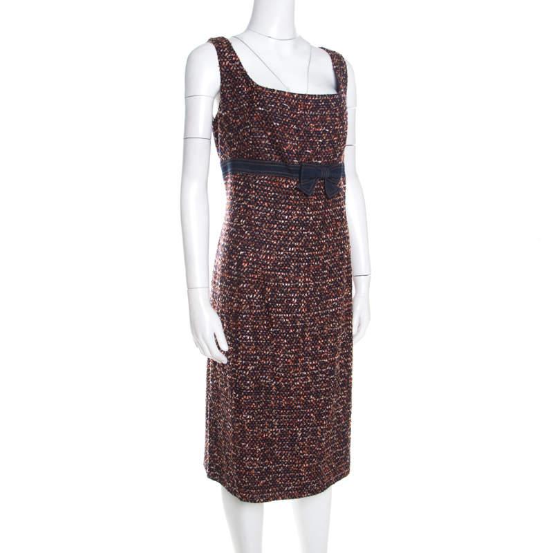 Isnt this sleeveless dress from Escada just lovely? This multicolored tweed dress features a chic design and flaunts a broad neckline  a denim bow detail at the waist  and a smart shift silhouette. It is sure to look amazing on you and can be paired