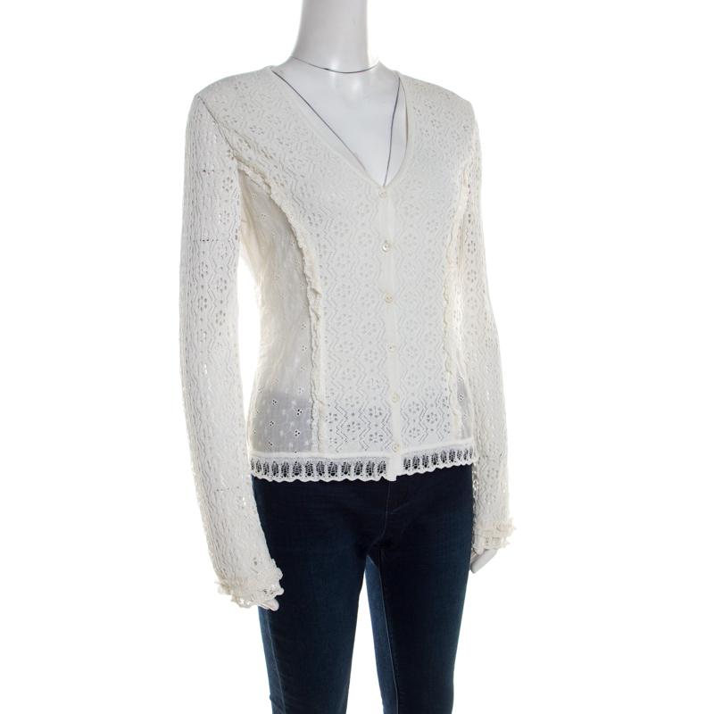 Modishly designed with a feminine approach, this Escada cardigan features an off-white hue and lace panels all over. This snug cardigan has button fastenings with long sleeves. Layer this over your casual separates to complete the look.

Includes:
