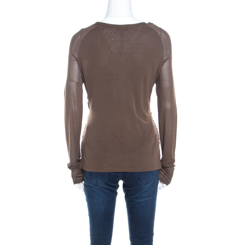 Sewn in quality fabric, this top from Escada features an interesting wrap design along with long sheer sleeves. Styled in solid olive green color, take this top into your daytime look with neutrally colored bottoms and loafers.

Includes: The Luxury