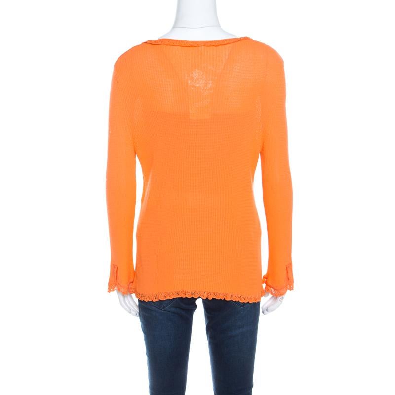 Escada delights us with this wonderful orange cardigan. It is knit from quality fabrics and styled with long sleeves, front buttons, and crochet trims. The cardigan will be a bright addition to your closet.

Includes: The Luxury Closet Packaging,